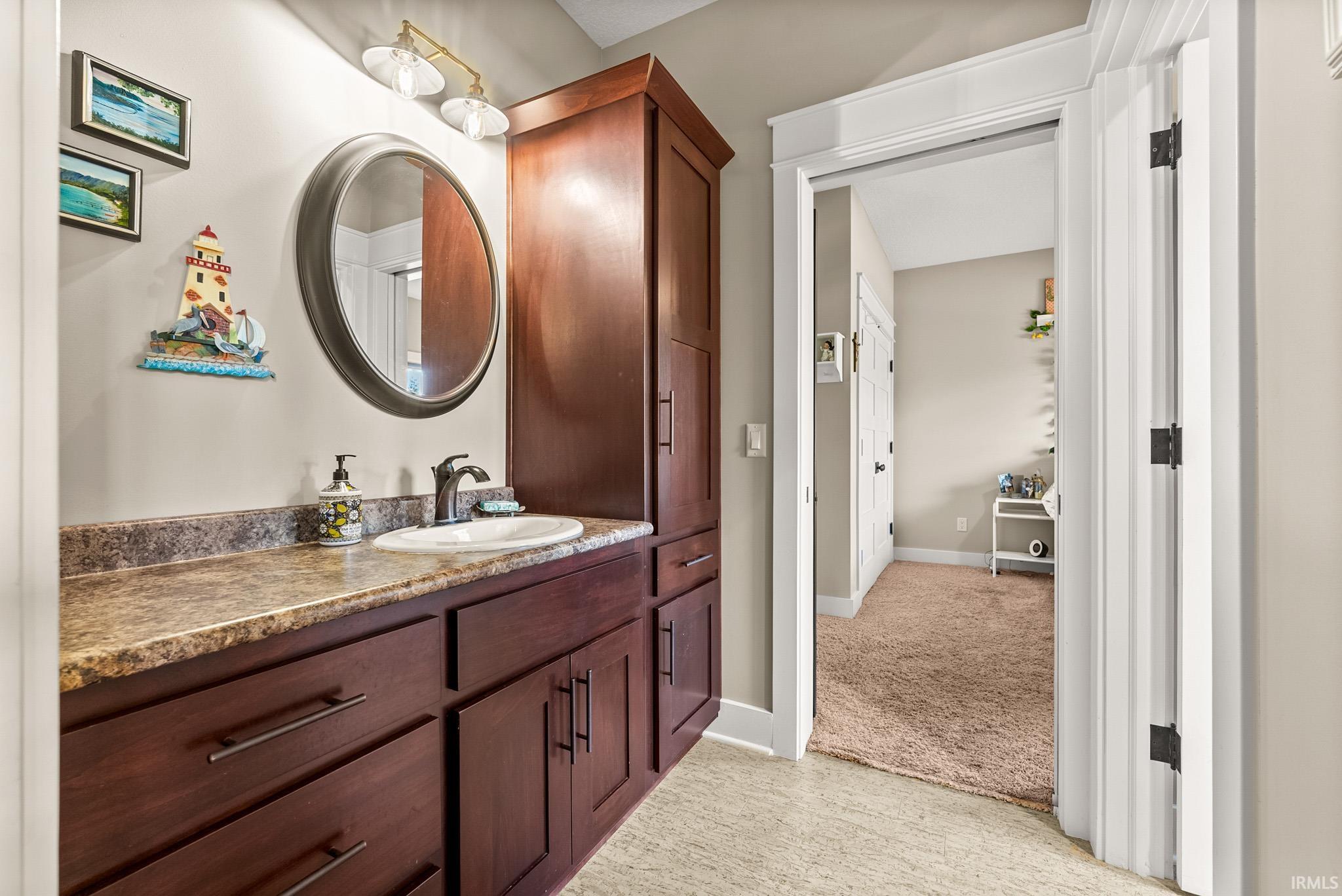 Bathroom with vanity and baseboards