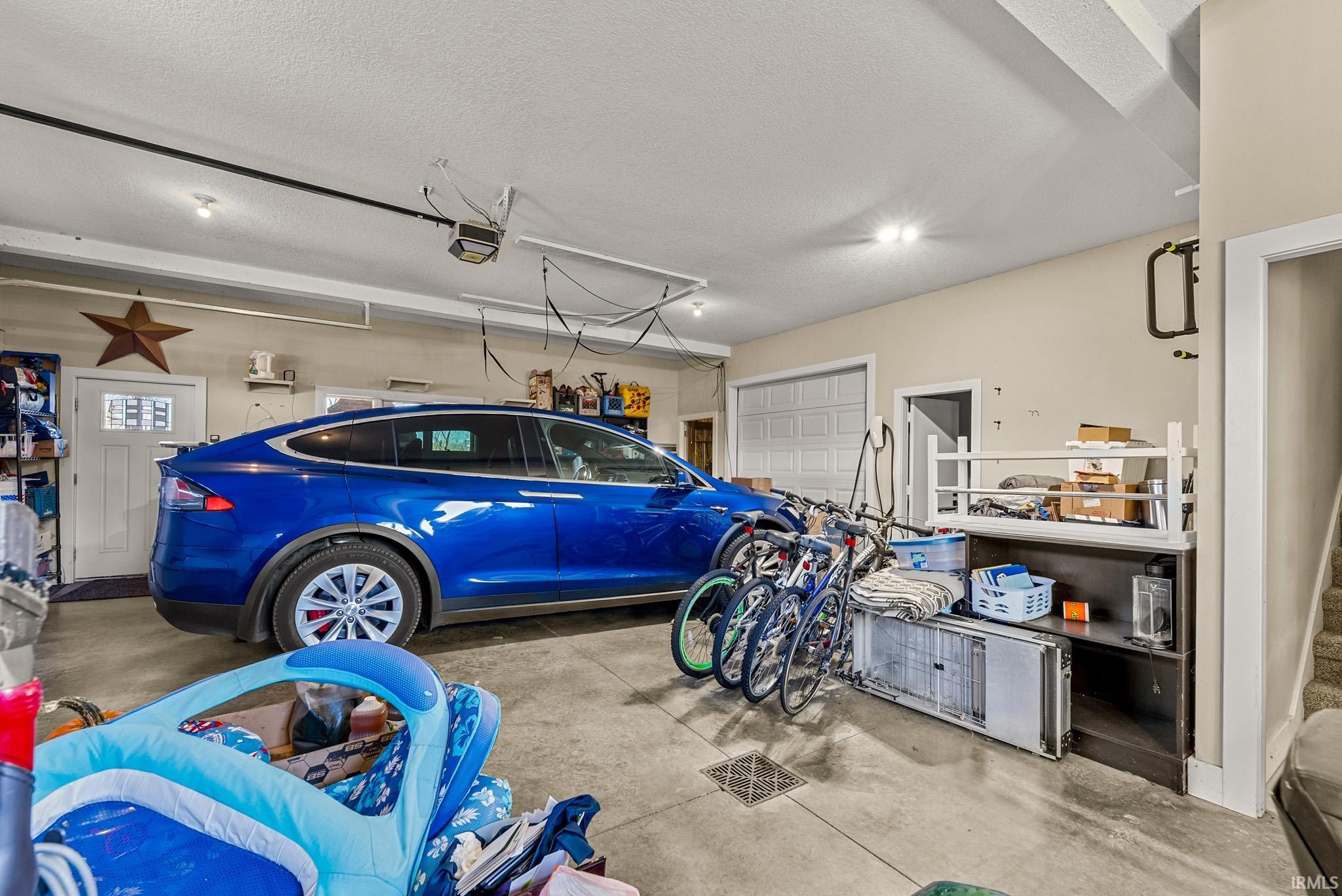 Garage featuring a garage door opener