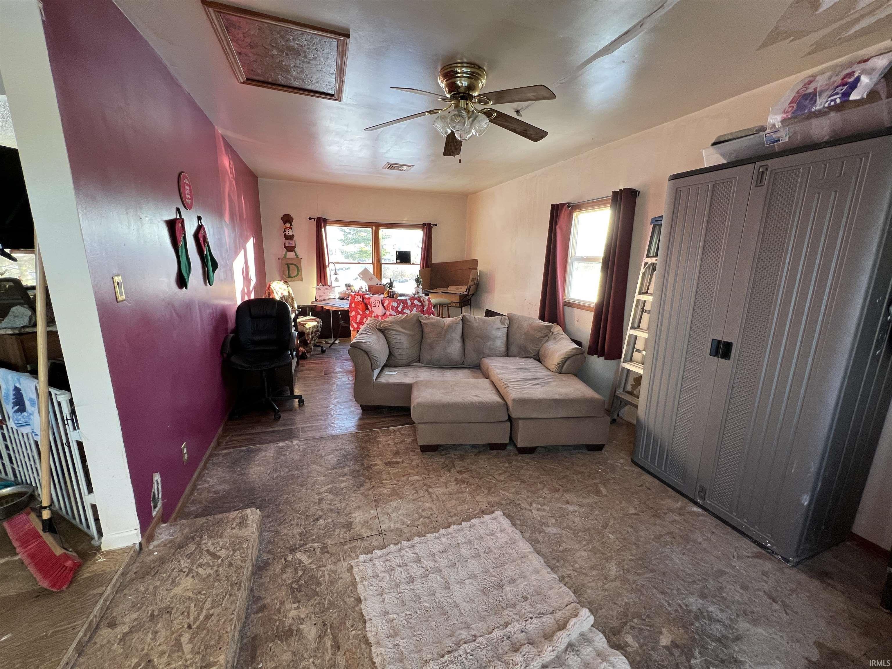 Living area with attic access and a ceiling fan