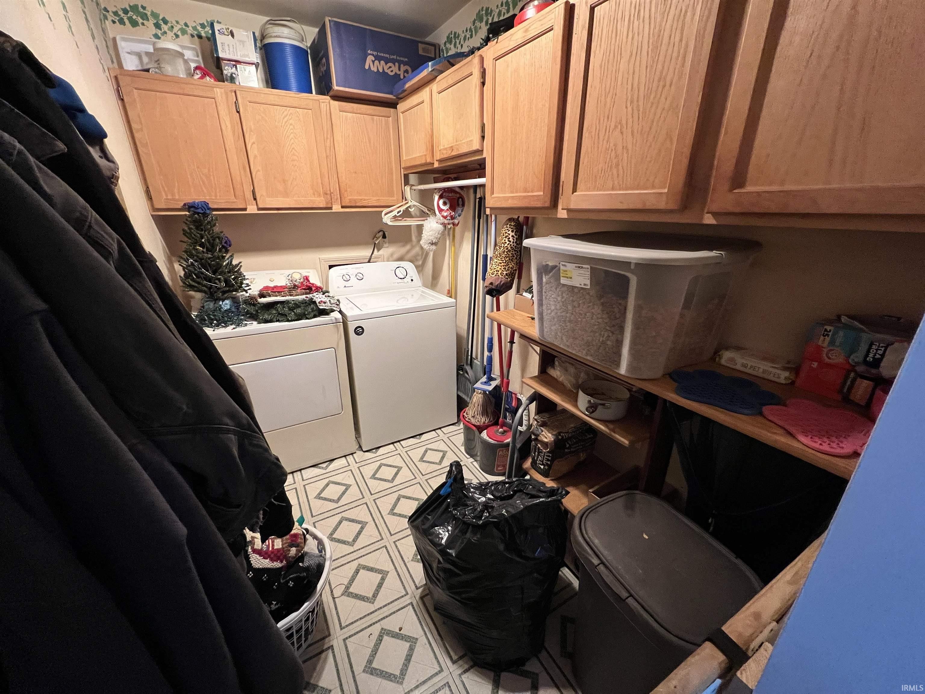 Laundry area with cabinet space and washing machine and clothes dryer