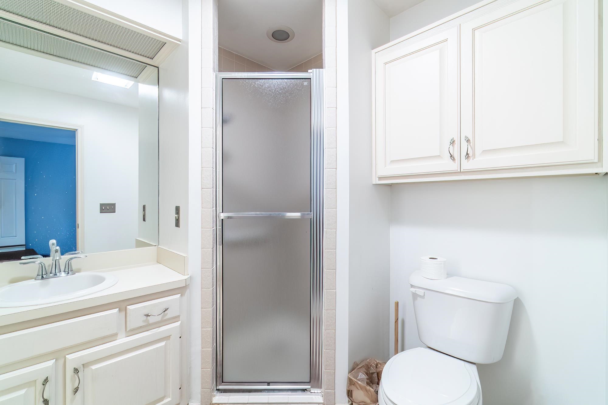 Bathroom featuring a shower stall and vanity