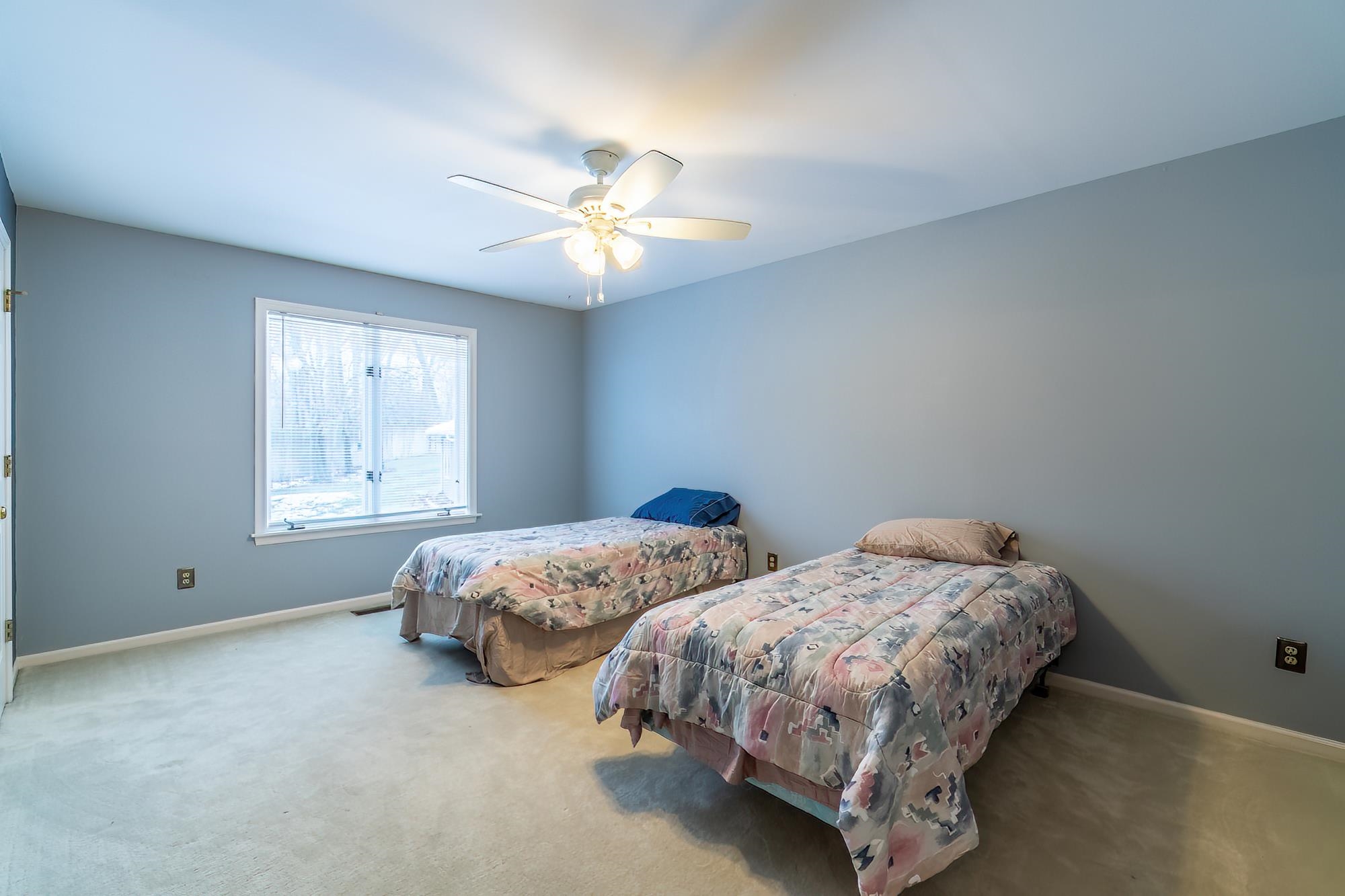 Bedroom featuring carpet and ceiling fan