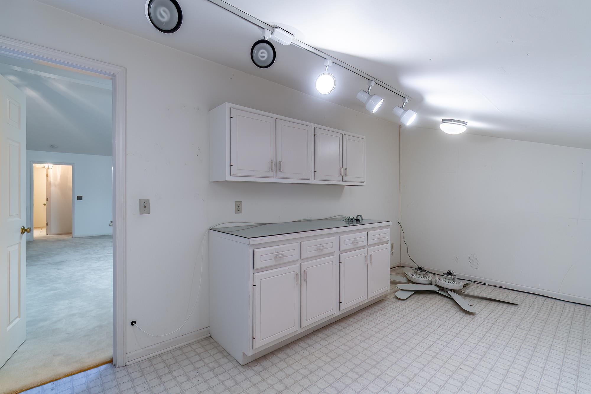 featuring light flooring and track lighting