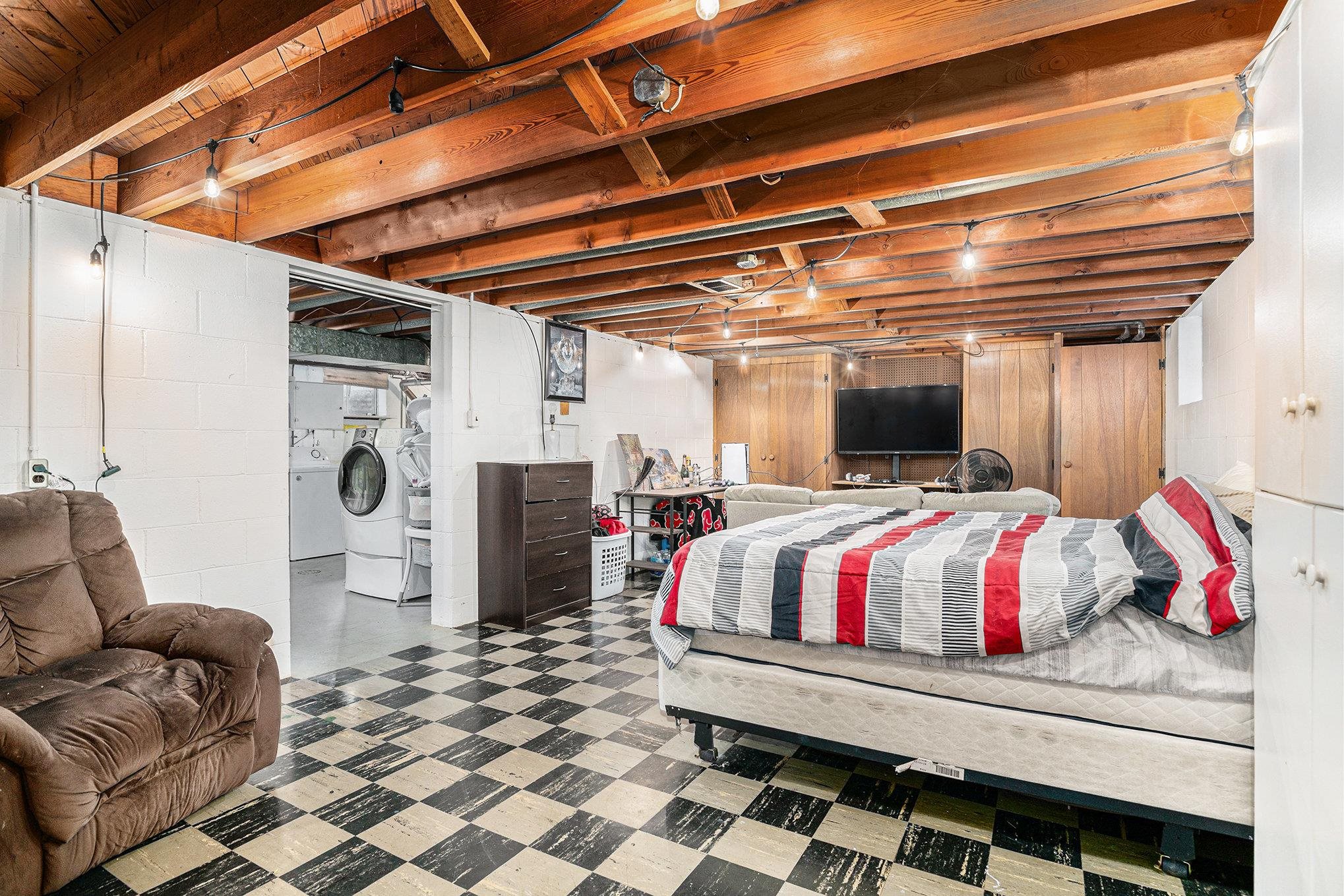 Bedroom featuring tile patterned floors and washer / dryer