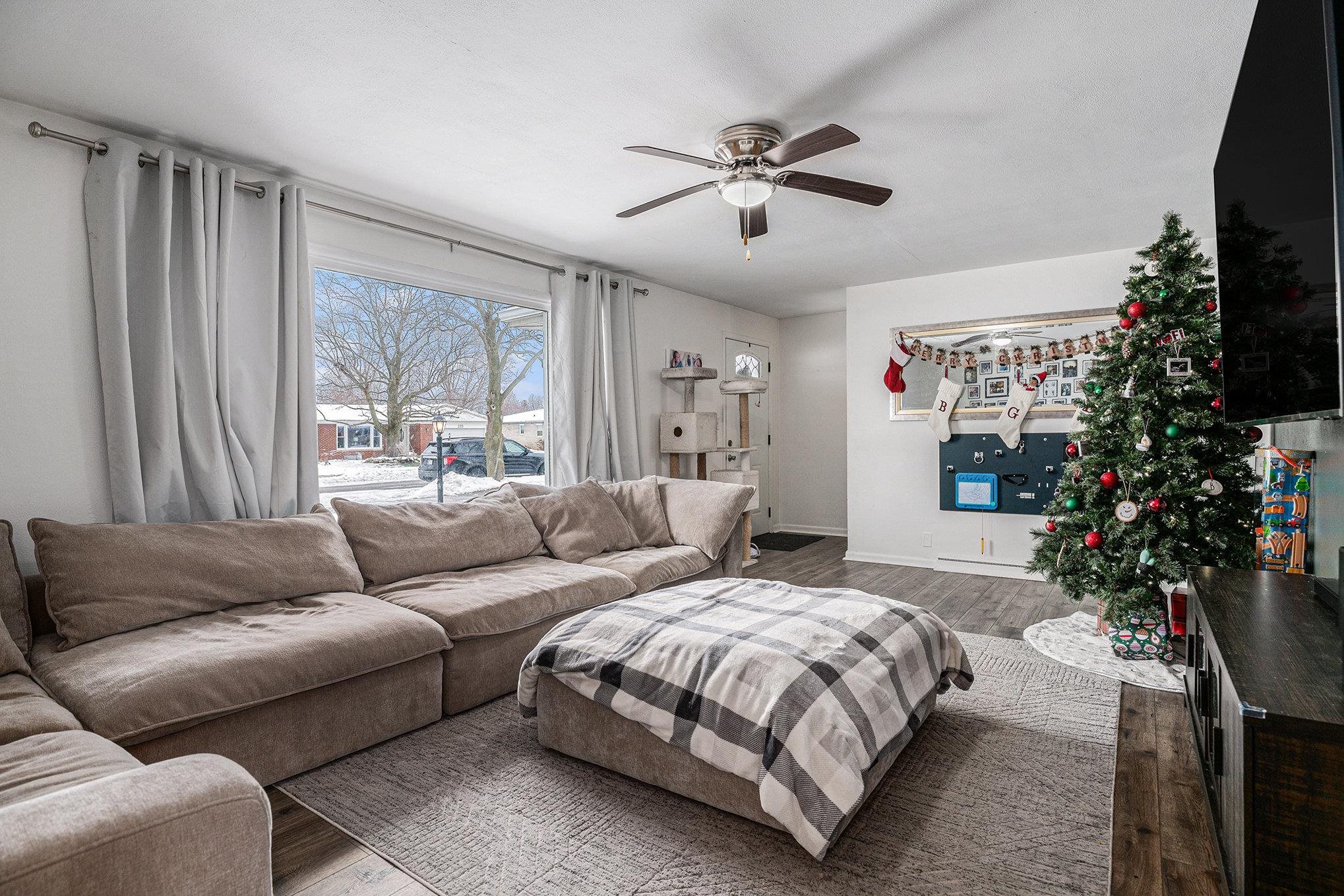 Living area featuring wood finished floors and a ceiling fan