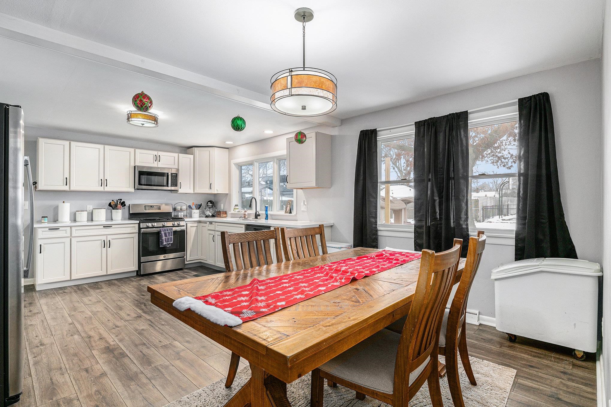 Dining room featuring light wood-style floors and baseboards