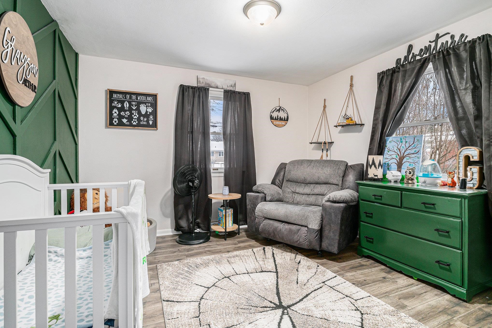 Bedroom featuring a crib and light wood-style floors