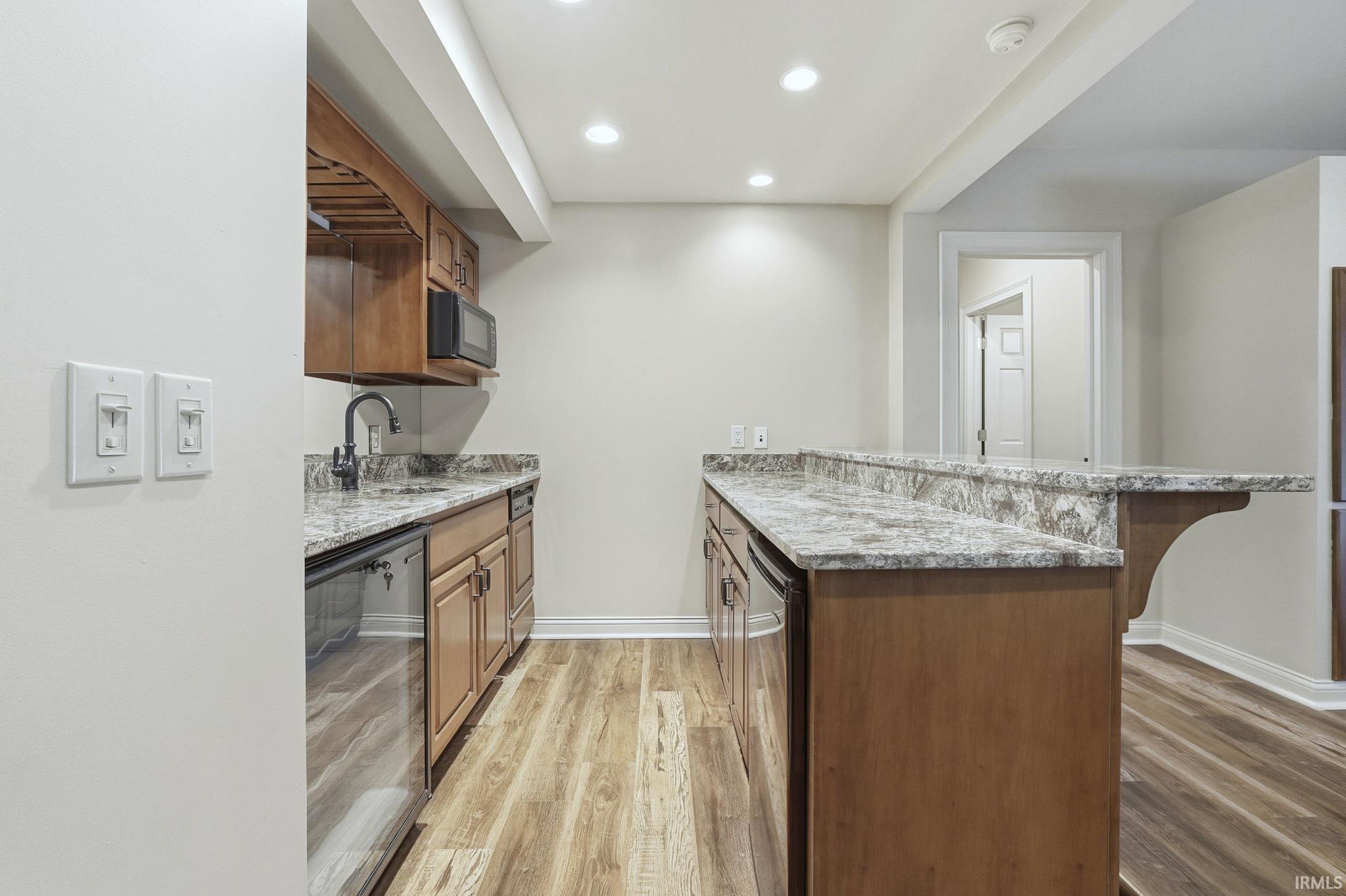 Kitchen with Beverage Cooler, wine glass rack, recessed lighting, Dishwasher and sink
