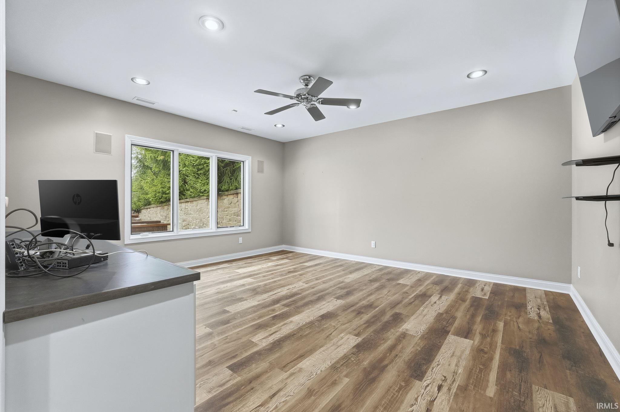 Features wall desk top with custom cabinetry, mounted TV.