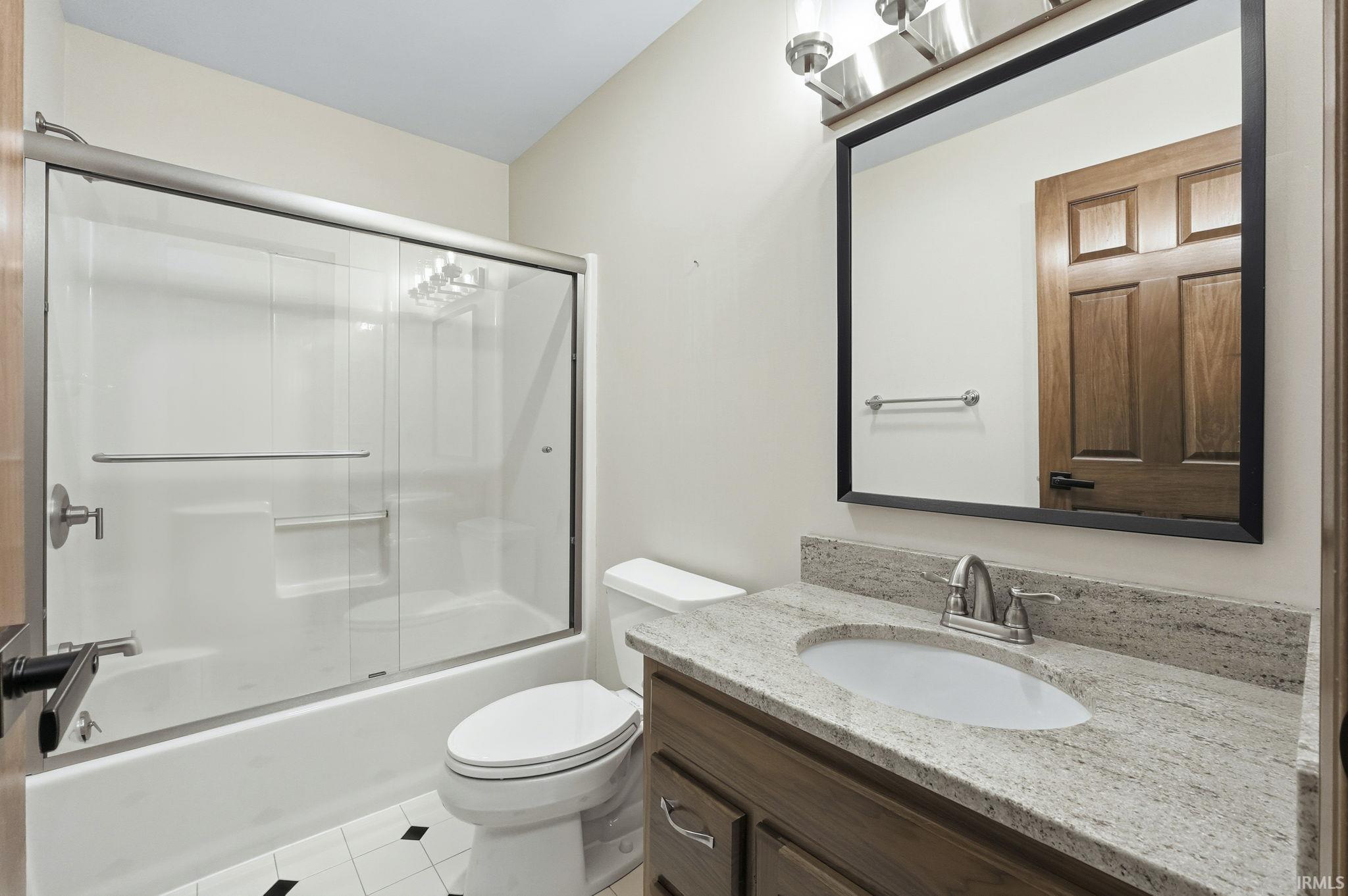 Full bath featuring enclosed tub / shower combo, Granite countertops, new mirrors, lighting