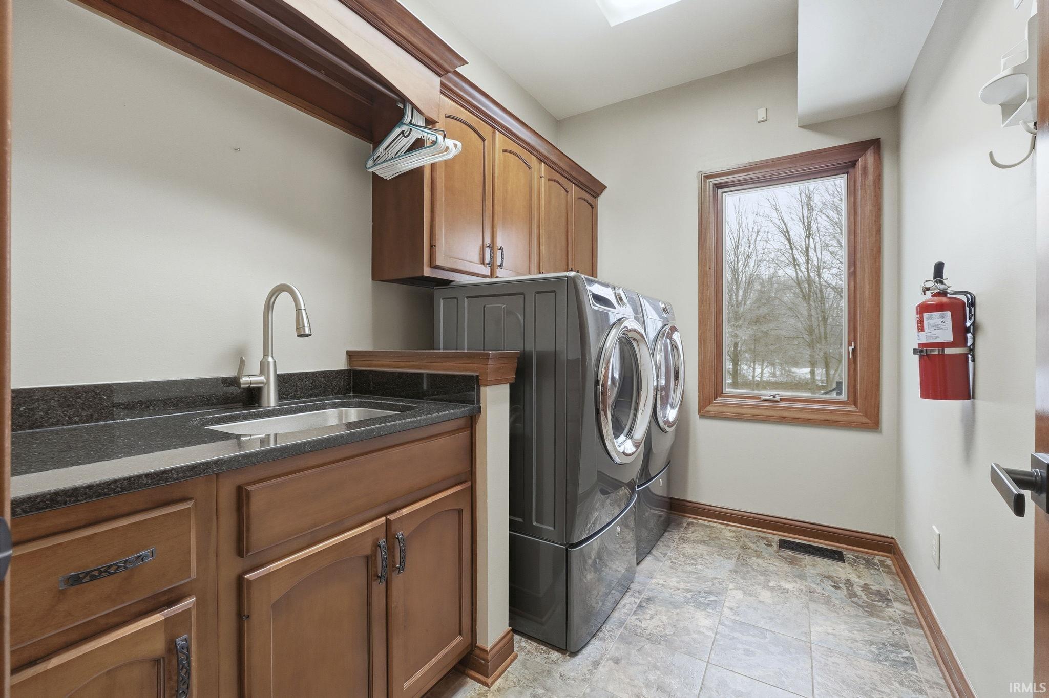 Washroom with cabinet space and independent washer and dryer