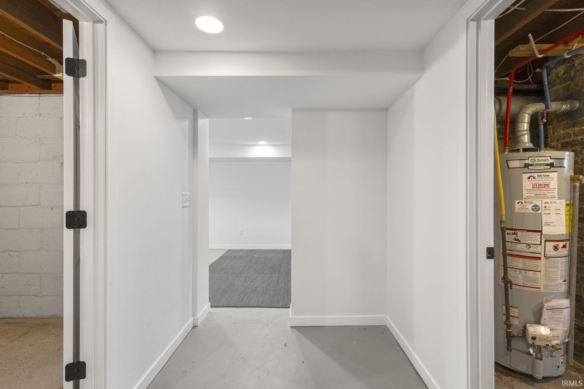 Corridor with concrete floors and water heater