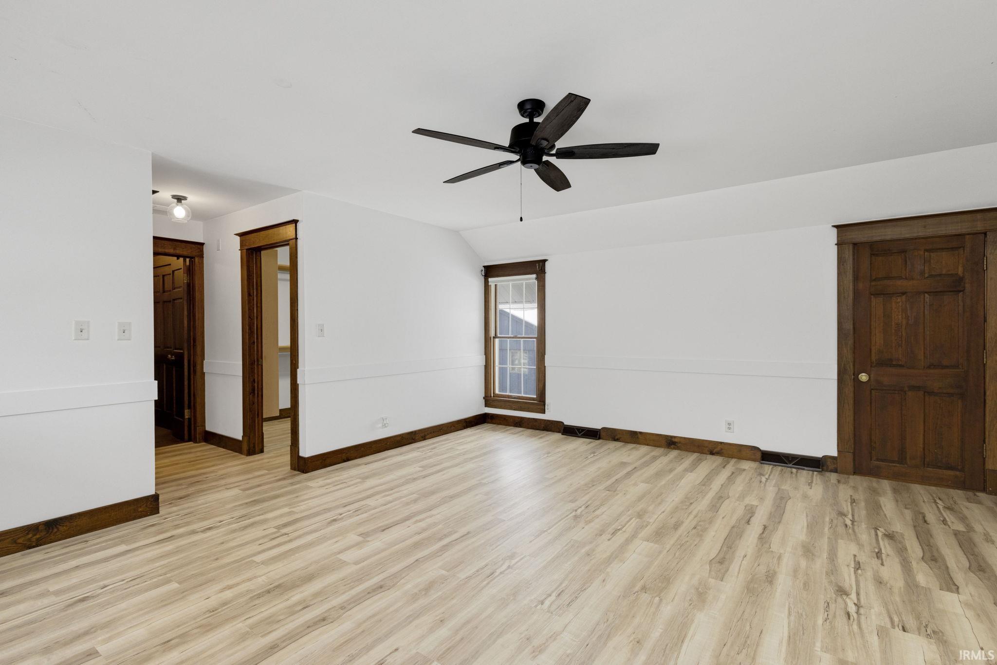 Spare room featuring light wood-style flooring and a ceiling fan