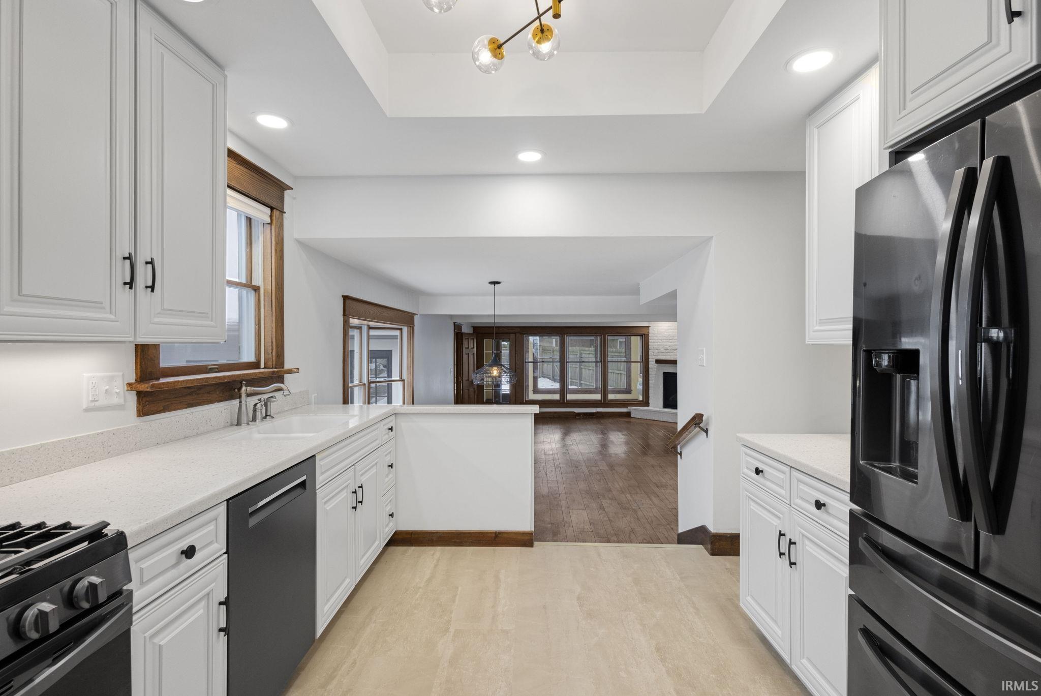 Kitchen featuring a chandelier, appliances with stainless steel finishes, white cabinets, and recessed lighting