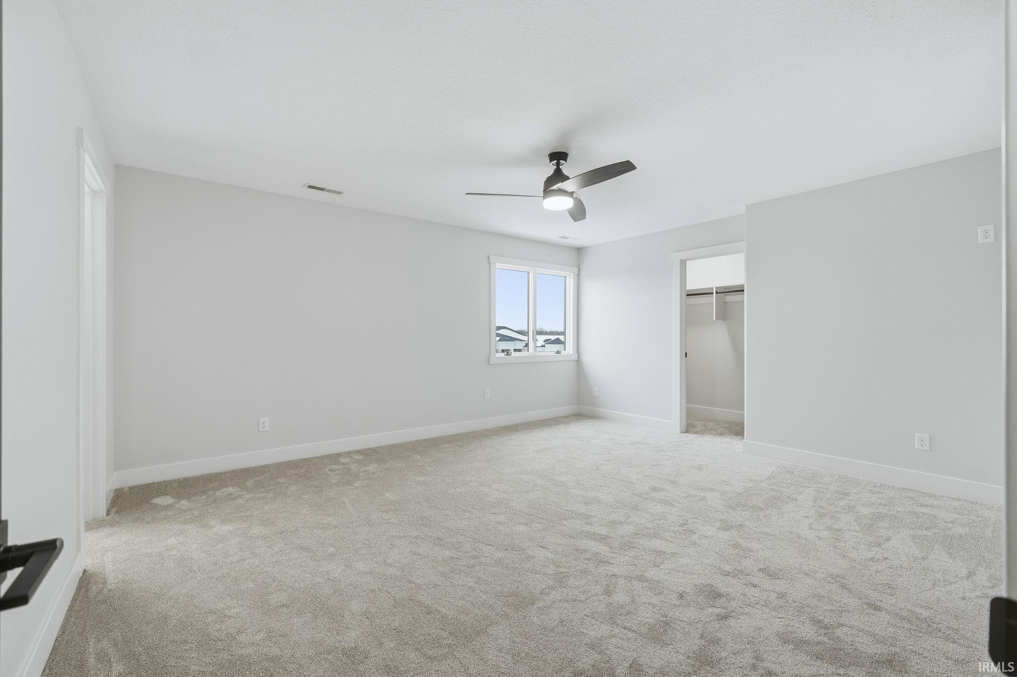 Unfurnished bedroom with a closet, ceiling fan, and light colored carpet
