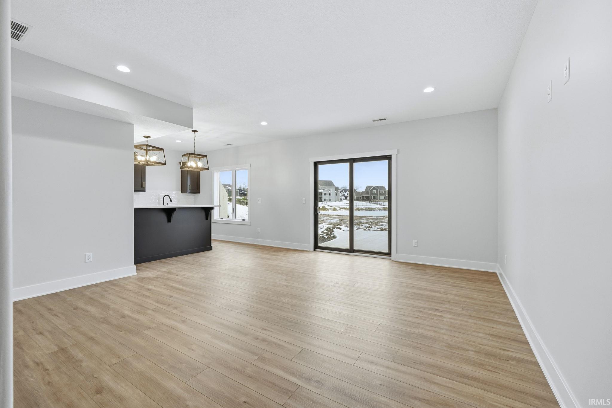 Unfurnished living room featuring light wood finished floors and recessed lighting
