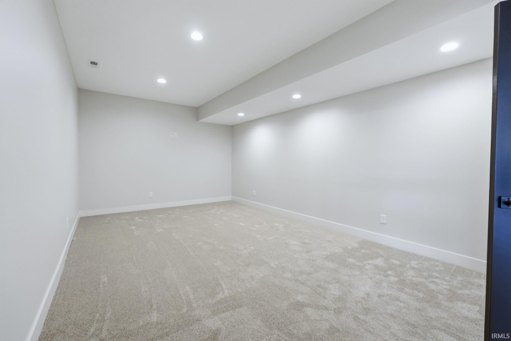 Spare room with recessed lighting and light carpet
