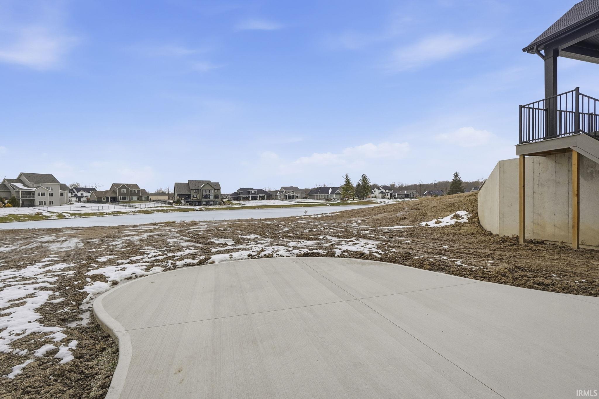 Yard covered in snow featuring a residential view