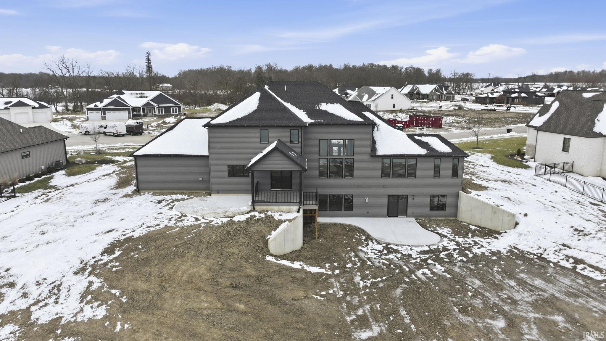 Snowy aerial view featuring a residential view