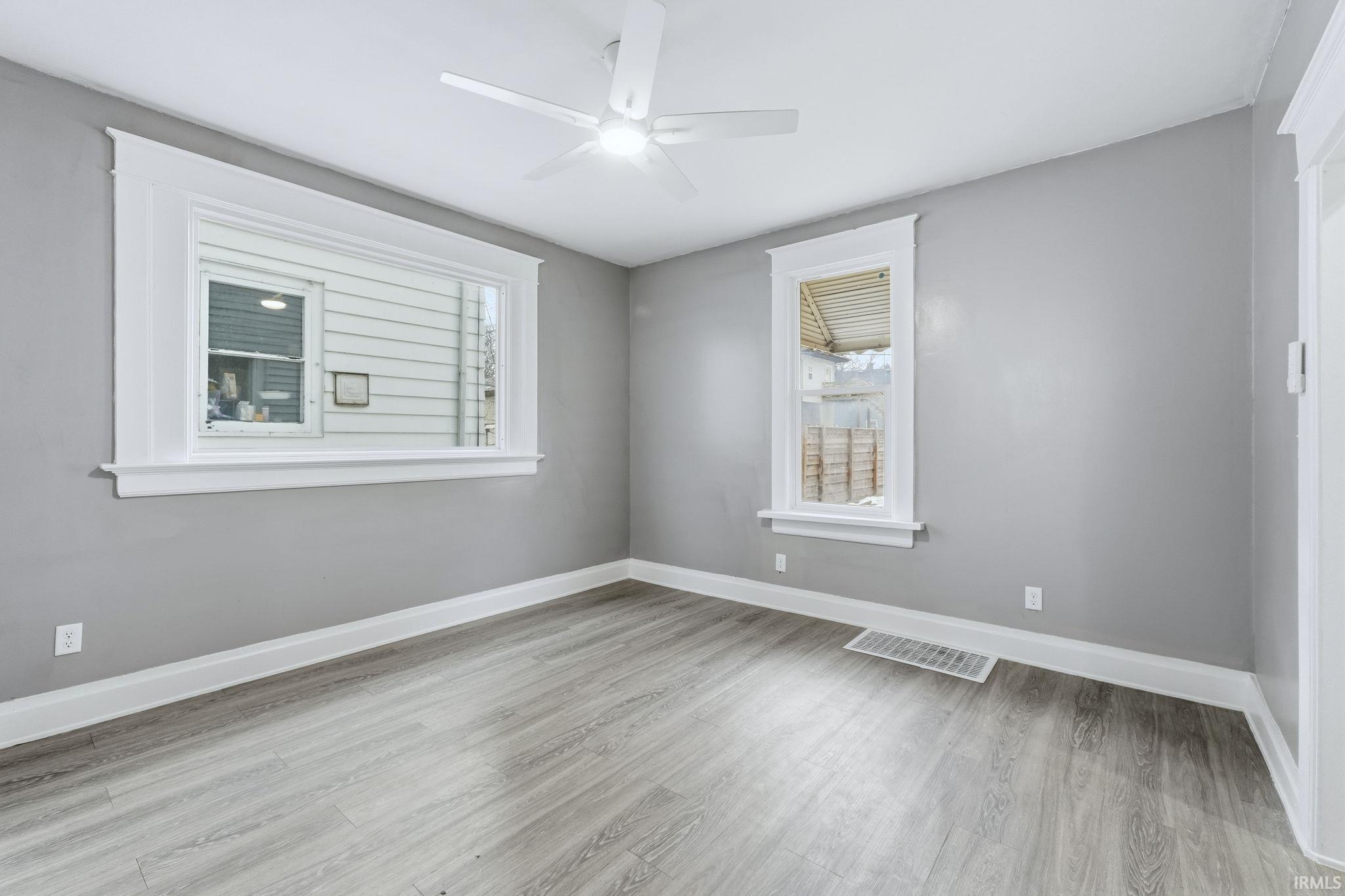 Spare room featuring light wood-type flooring and ceiling fan