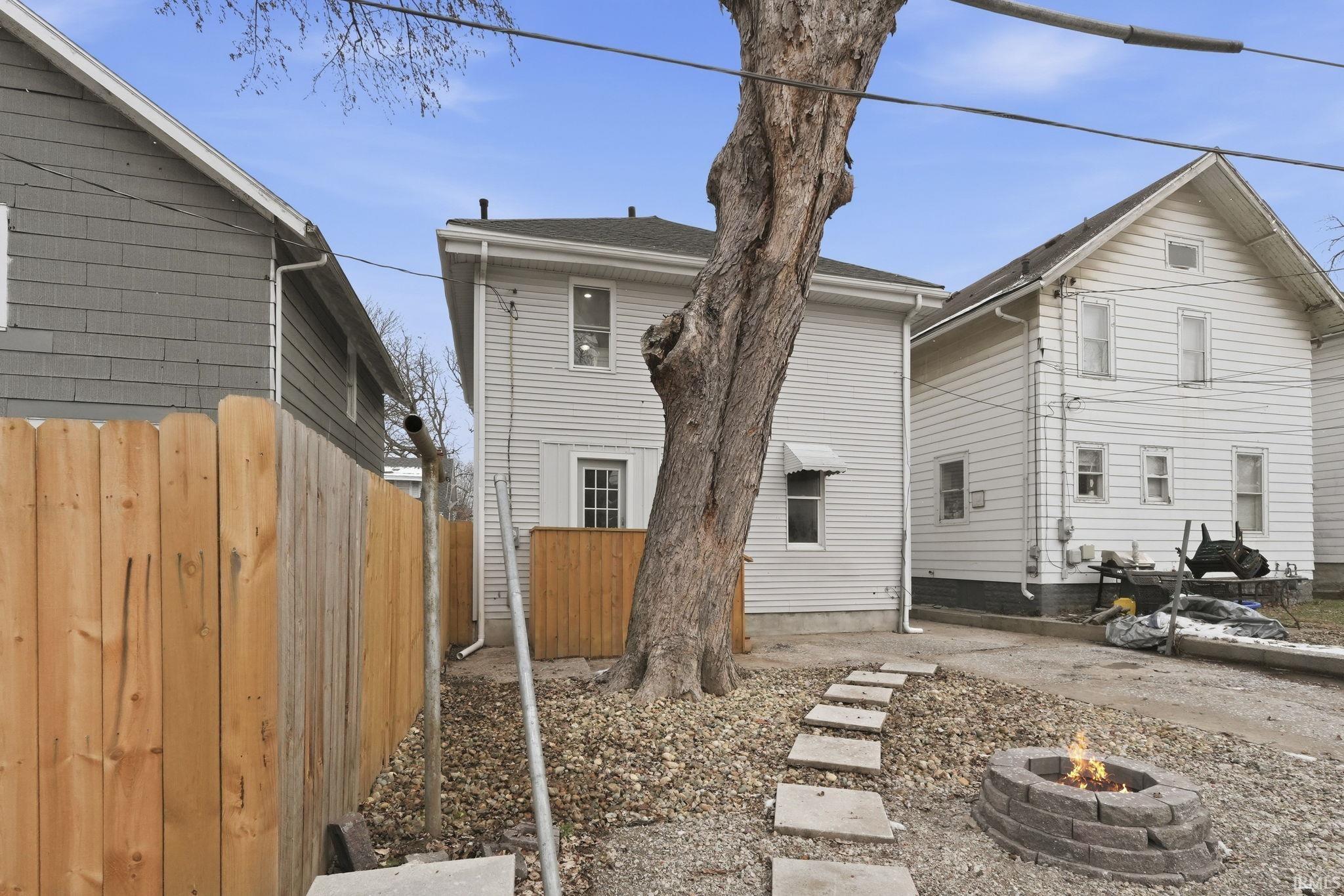 Back of property featuring a fire pit