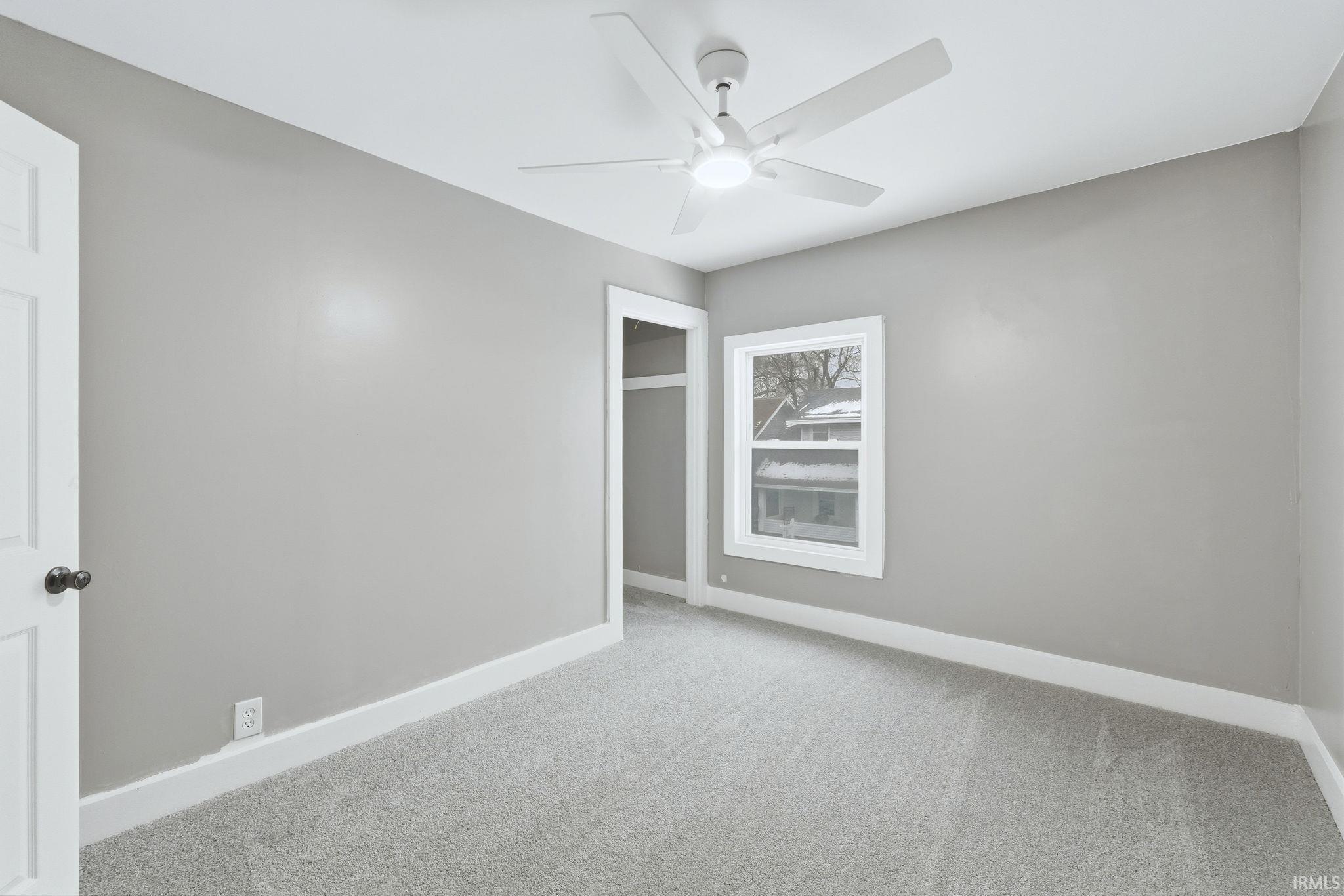 Unfurnished room with carpet floors and a ceiling fan