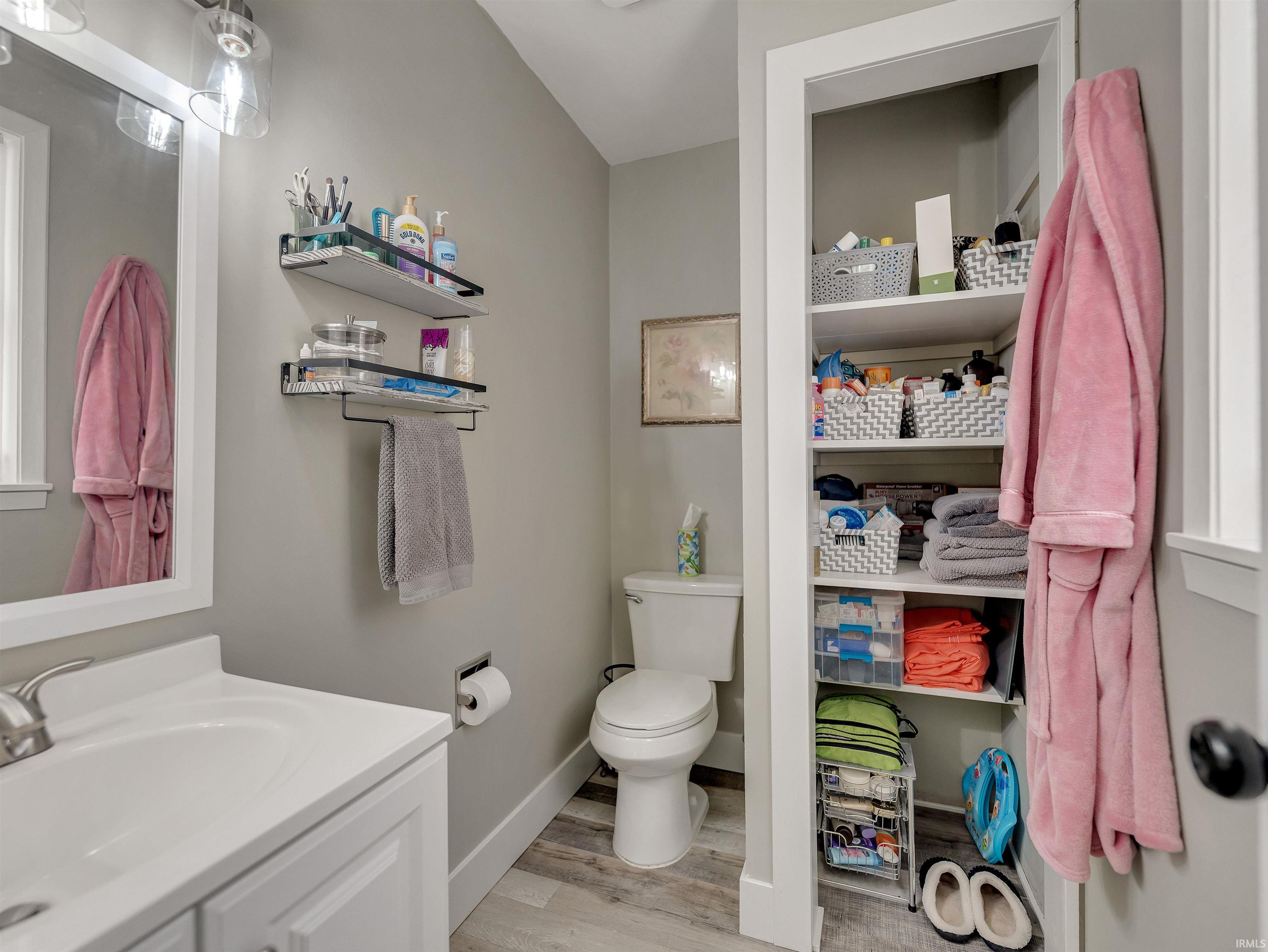 Half bathroom with vanity and light wood-type flooring