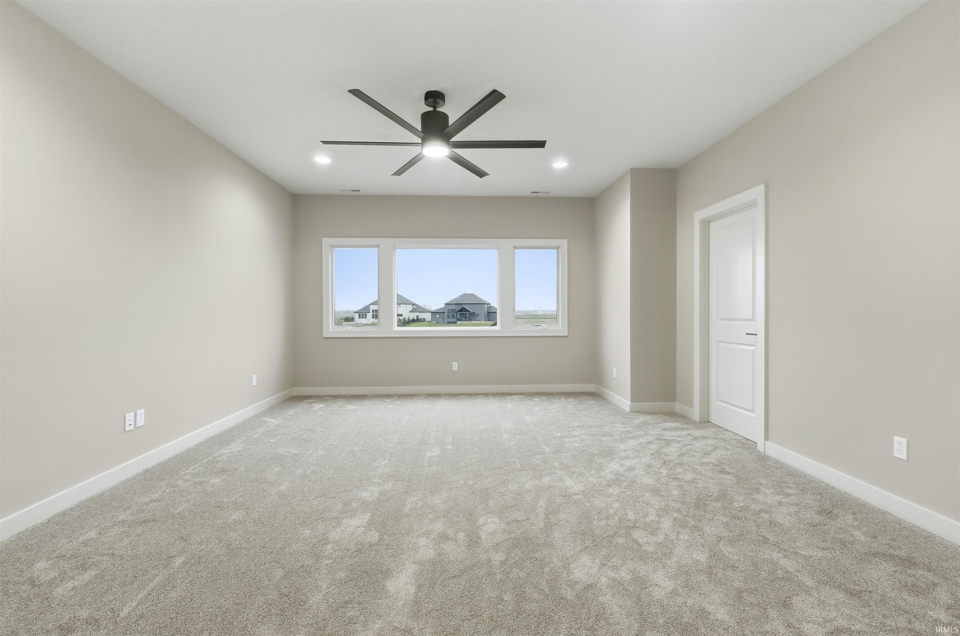 Spare room featuring carpet flooring, ceiling fan, and recessed lighting
