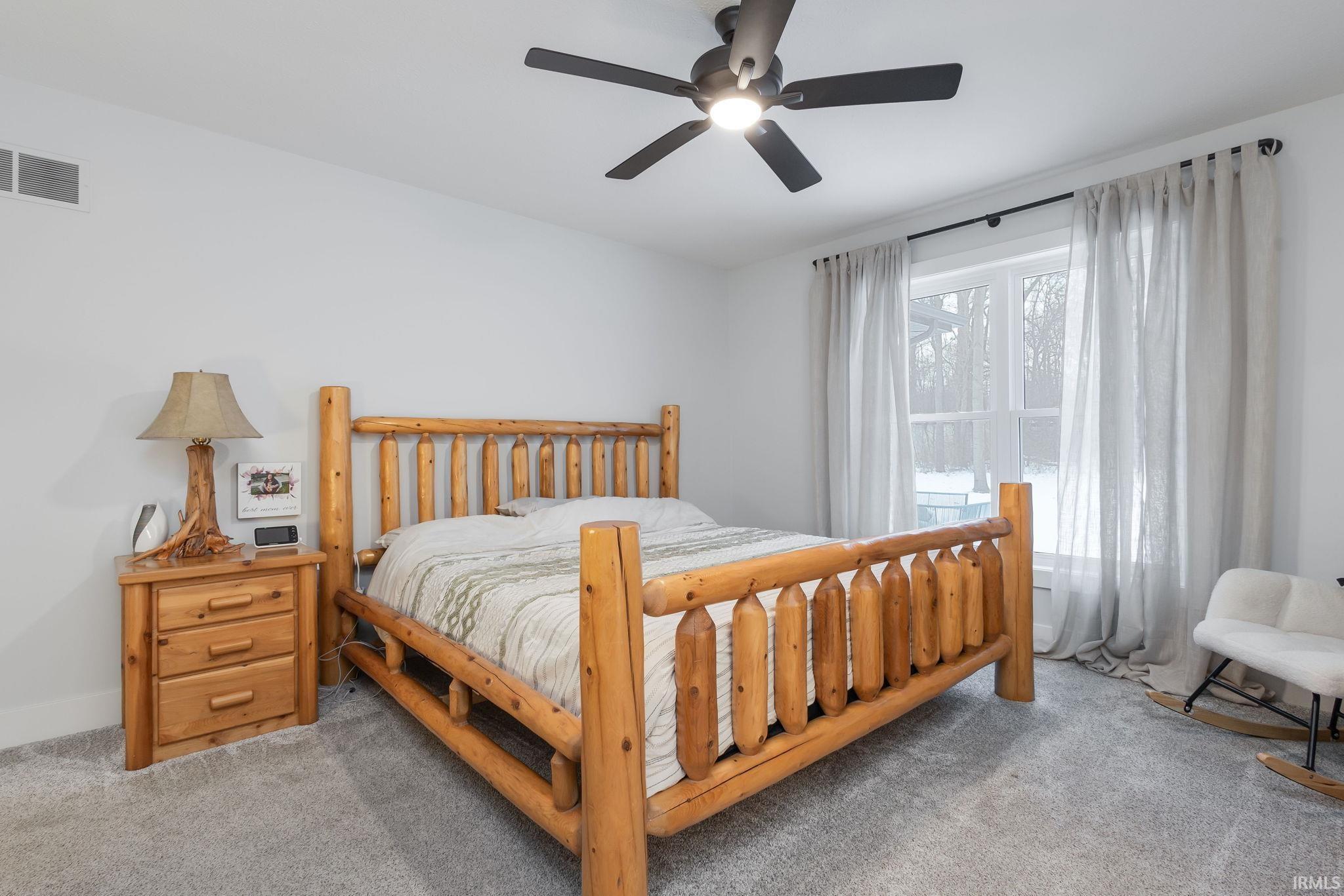 Bedroom with a ceiling fan and carpet flooring