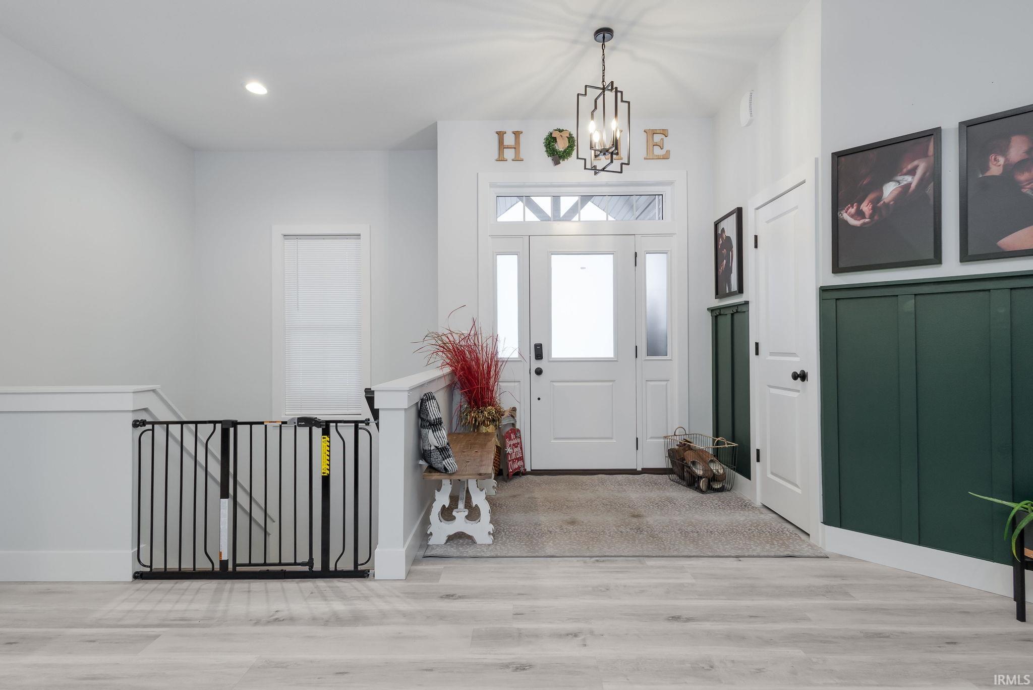 Foyer featuring wood finished floors, a chandelier, and recessed lighting