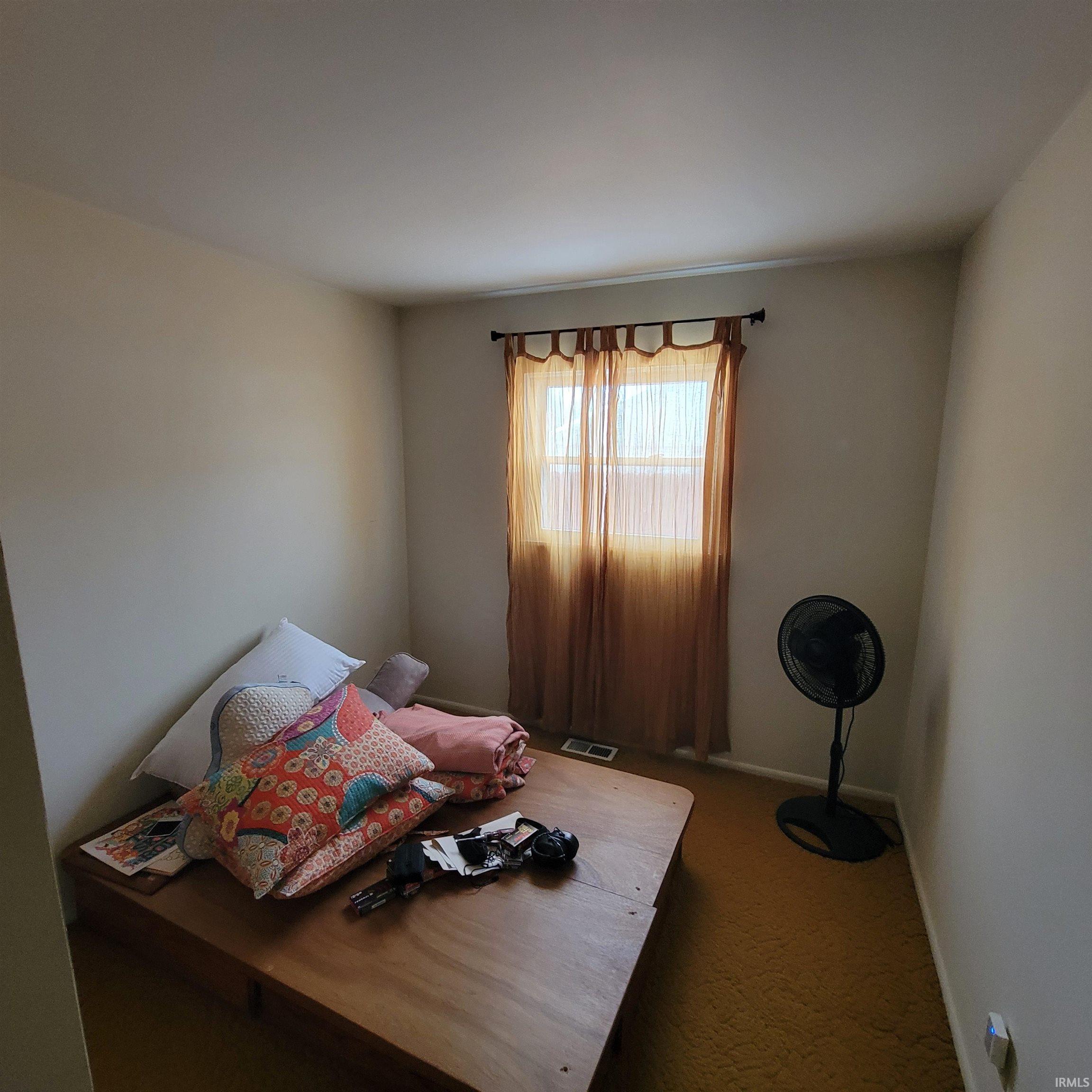 Bedroom featuring baseboards and carpet floors