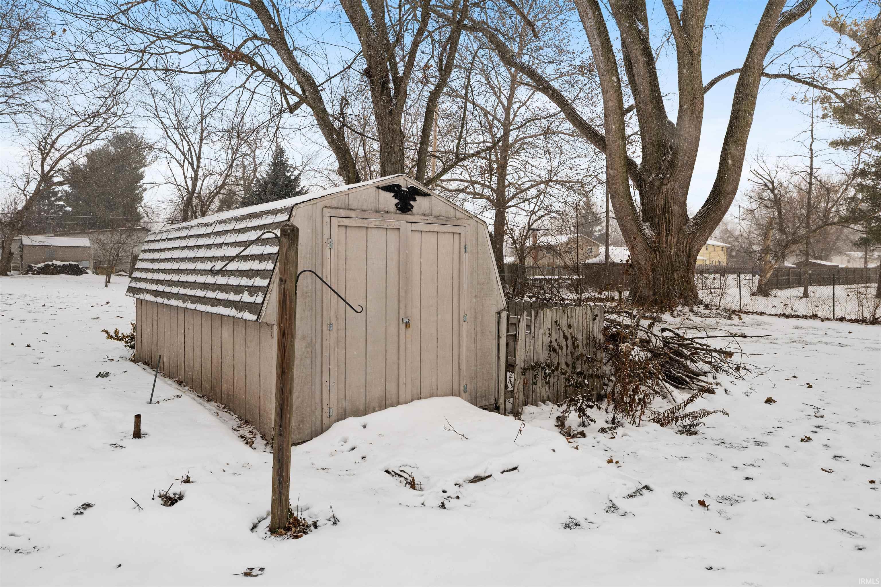 Snow covered structure with a storage shed