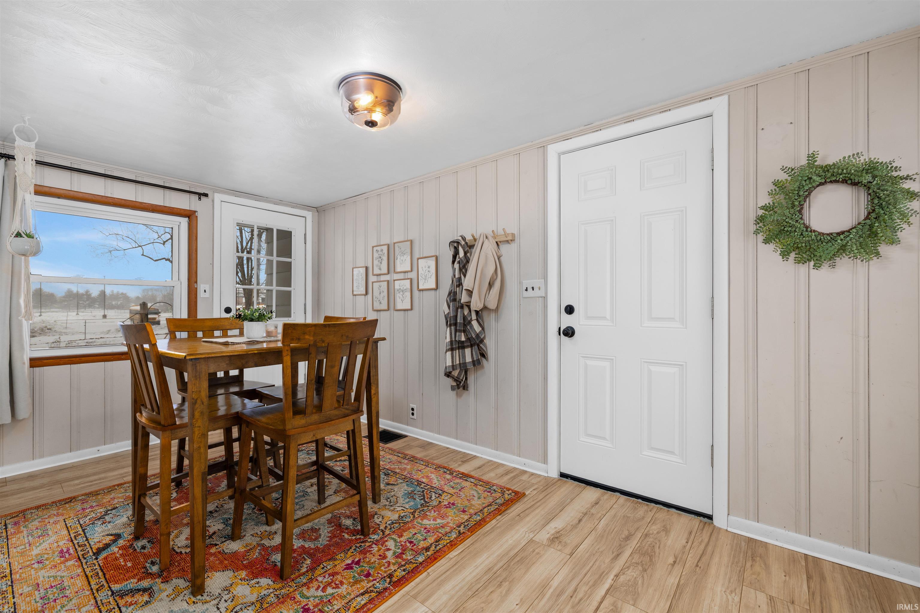 Dining space with light wood-style flooring and baseboards