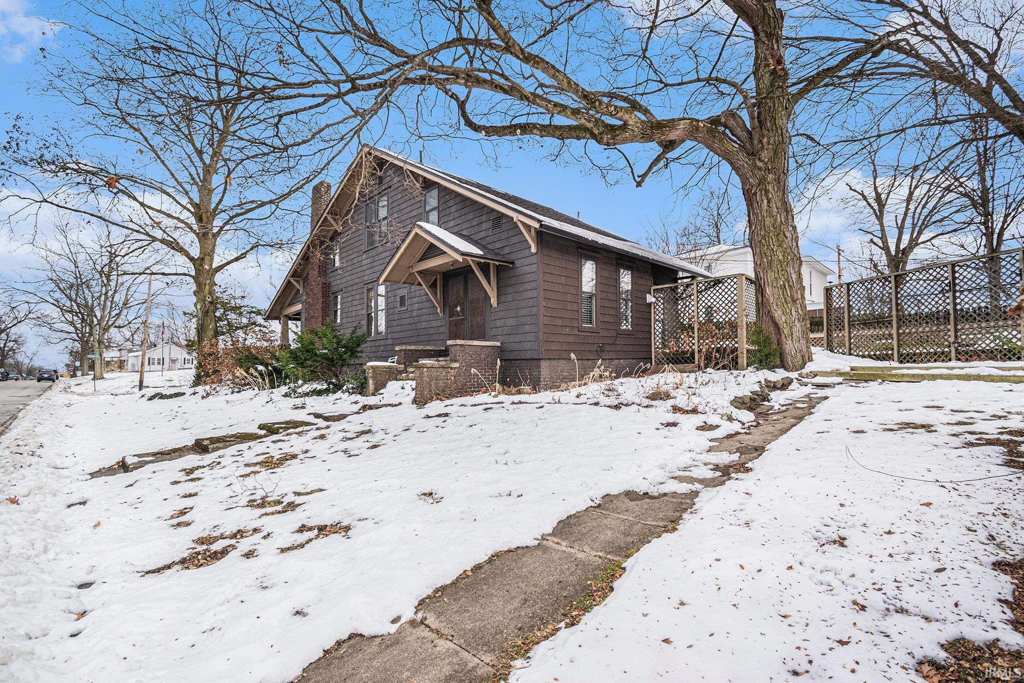 View of snowy exterior with a chimney