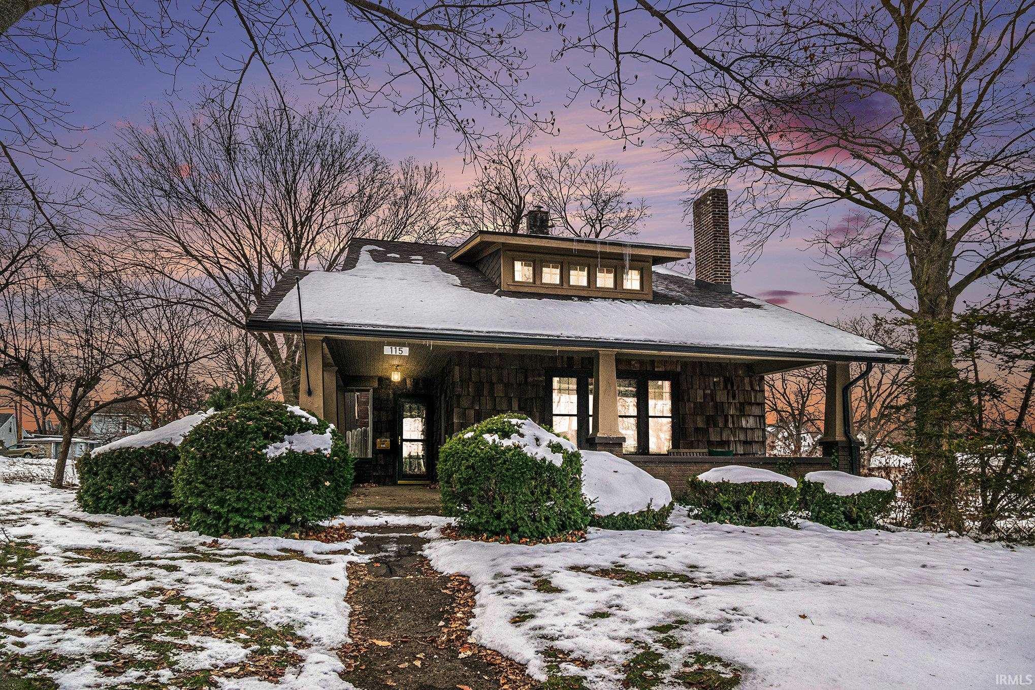 View of front of property featuring covered porch and a chimney