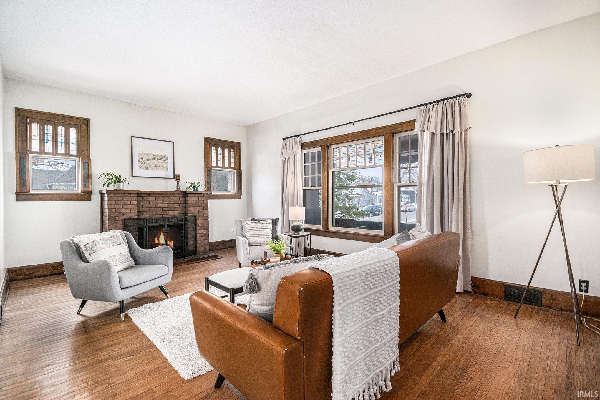 Living area with a fireplace and hardwood / wood-style floors