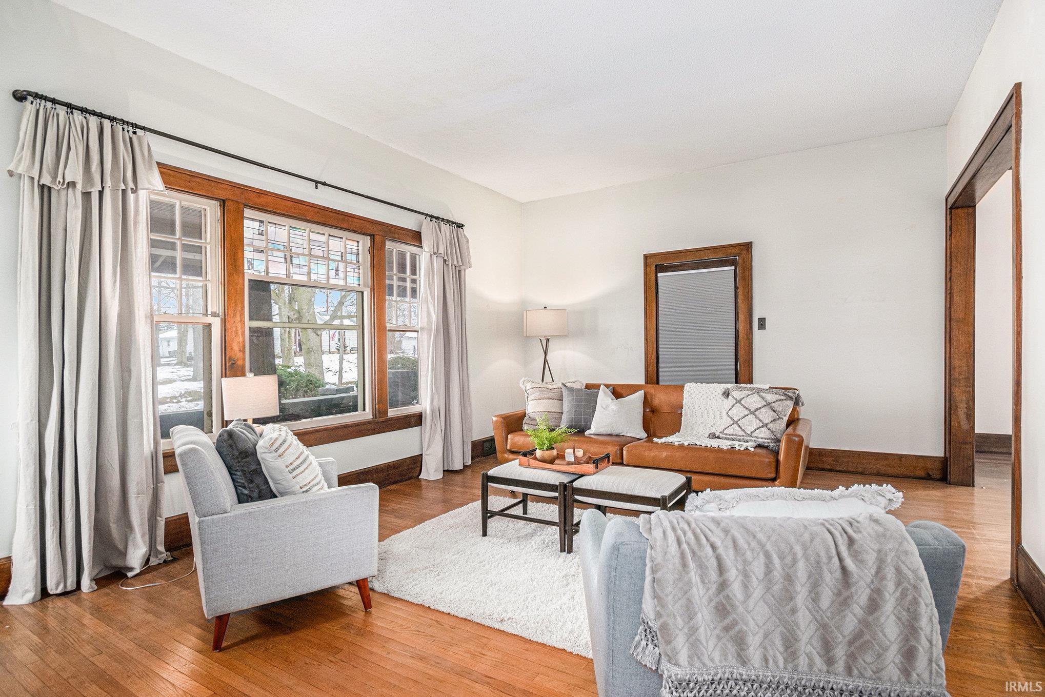 Living area with hardwood / wood-style flooring and baseboards