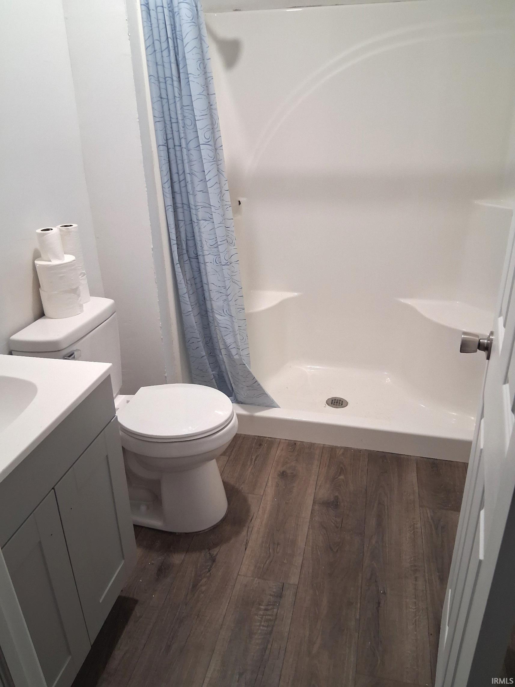 Full bathroom with a shower tub, vanity, and LVP floors