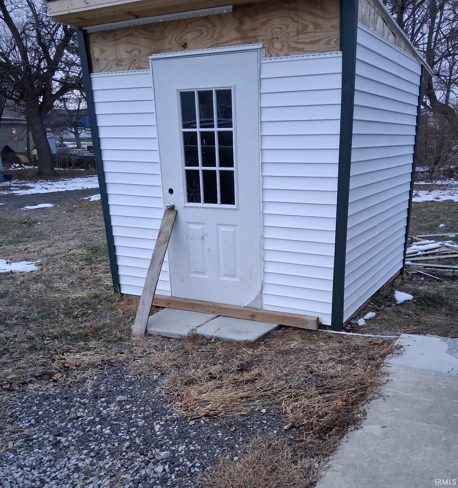 Snow covered structure with a shed