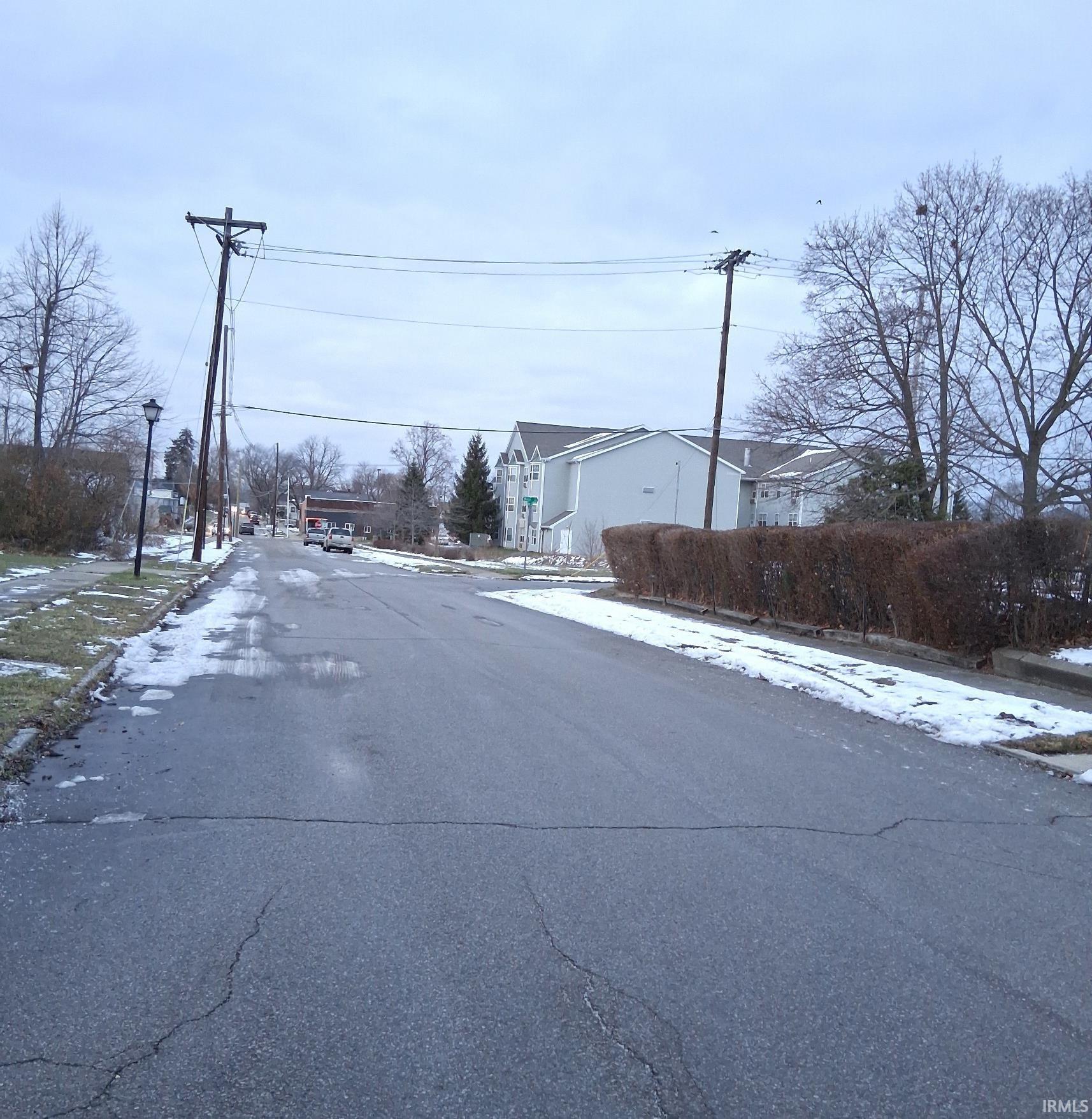 View of asphalt road with street lighting and sidewalks