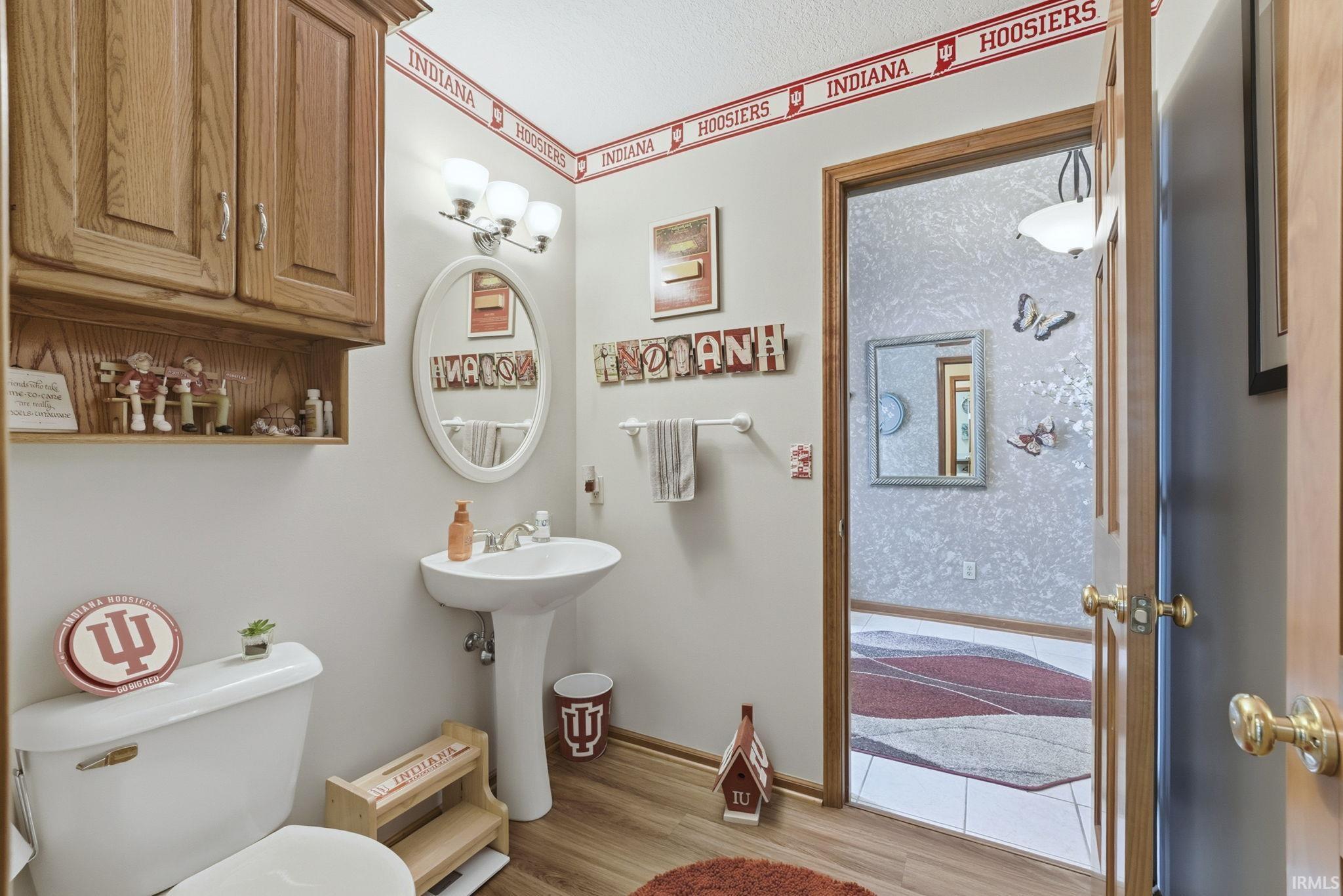 Bathroom with light wood-style floors and toilet