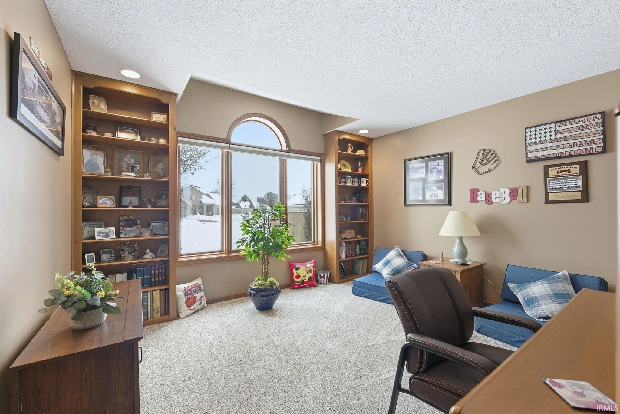 Office featuring a textured ceiling, built in features, carpet floors, and recessed lighting