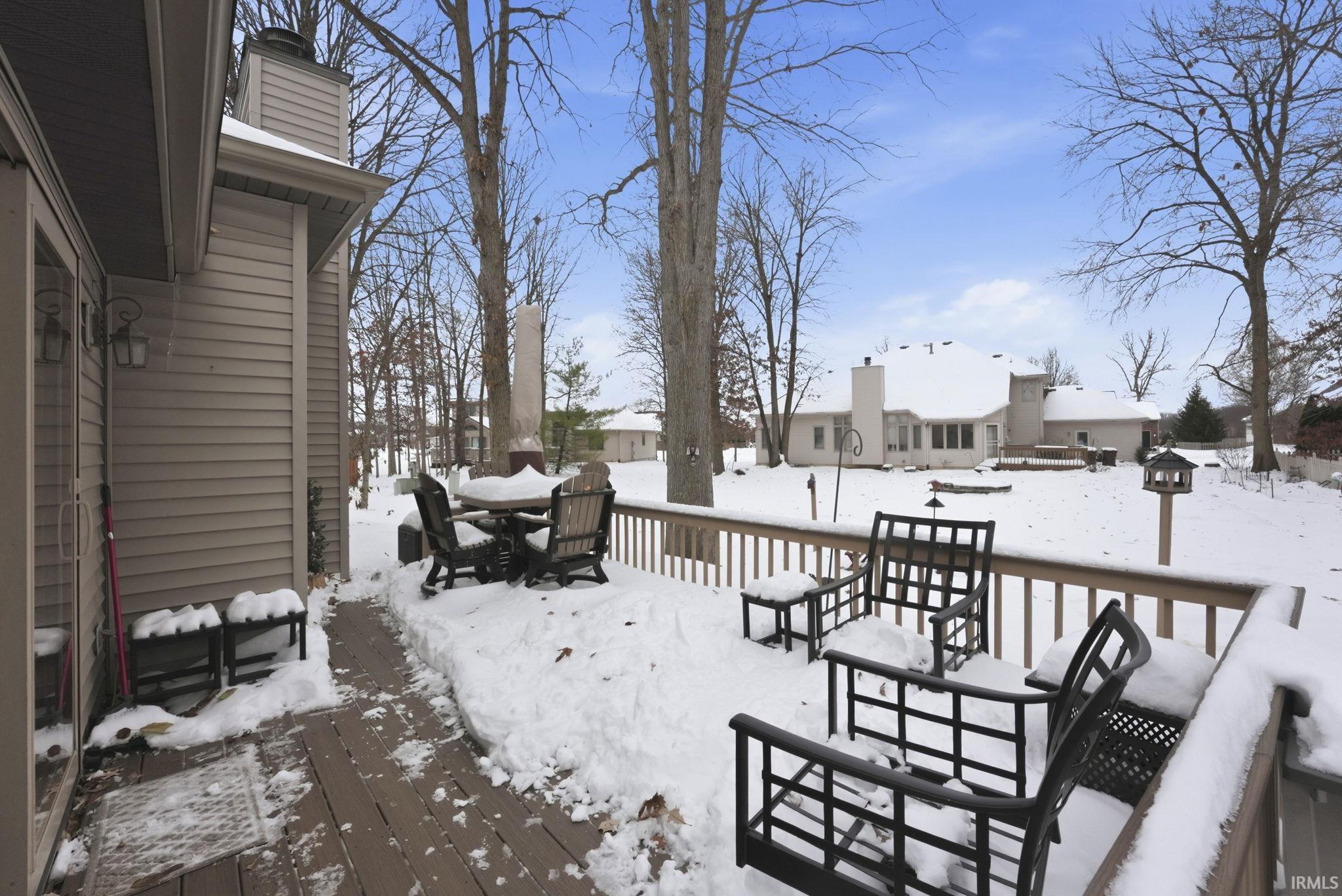 Snow covered deck with outdoor dining area