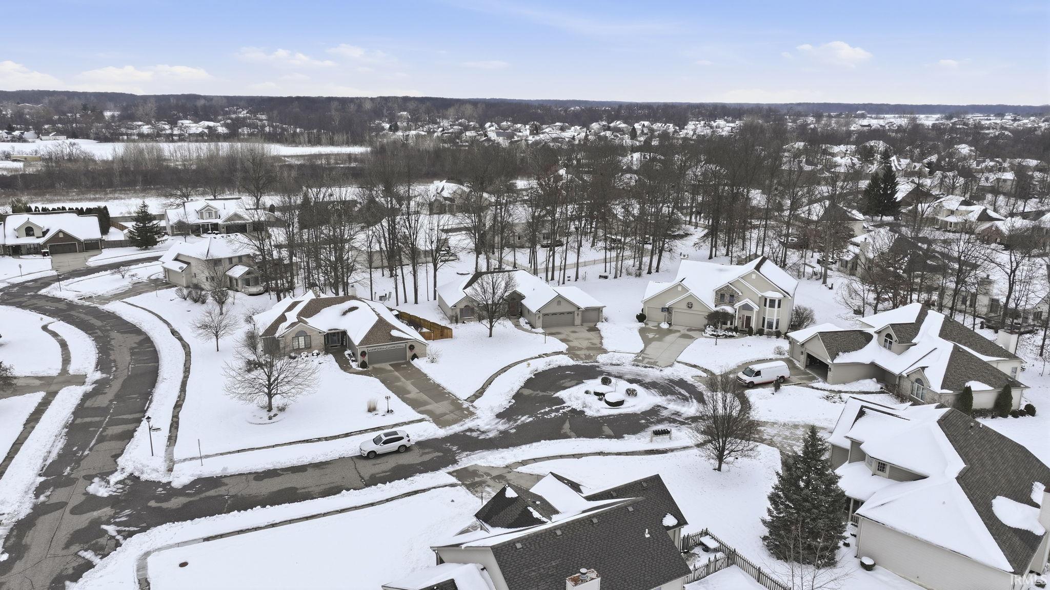 Snowy aerial view featuring a residential view