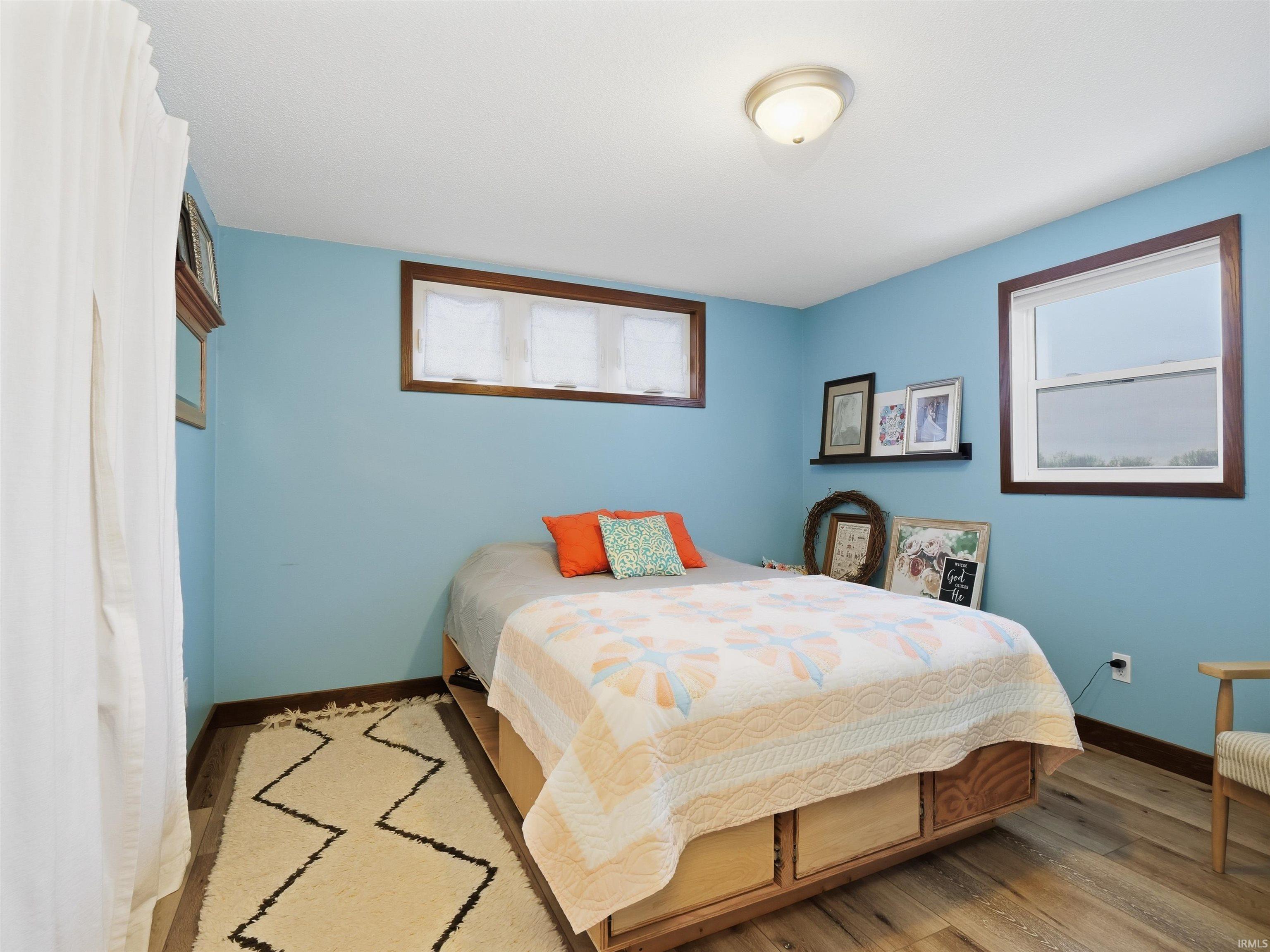 Bedroom featuring LVP floors and baseboards