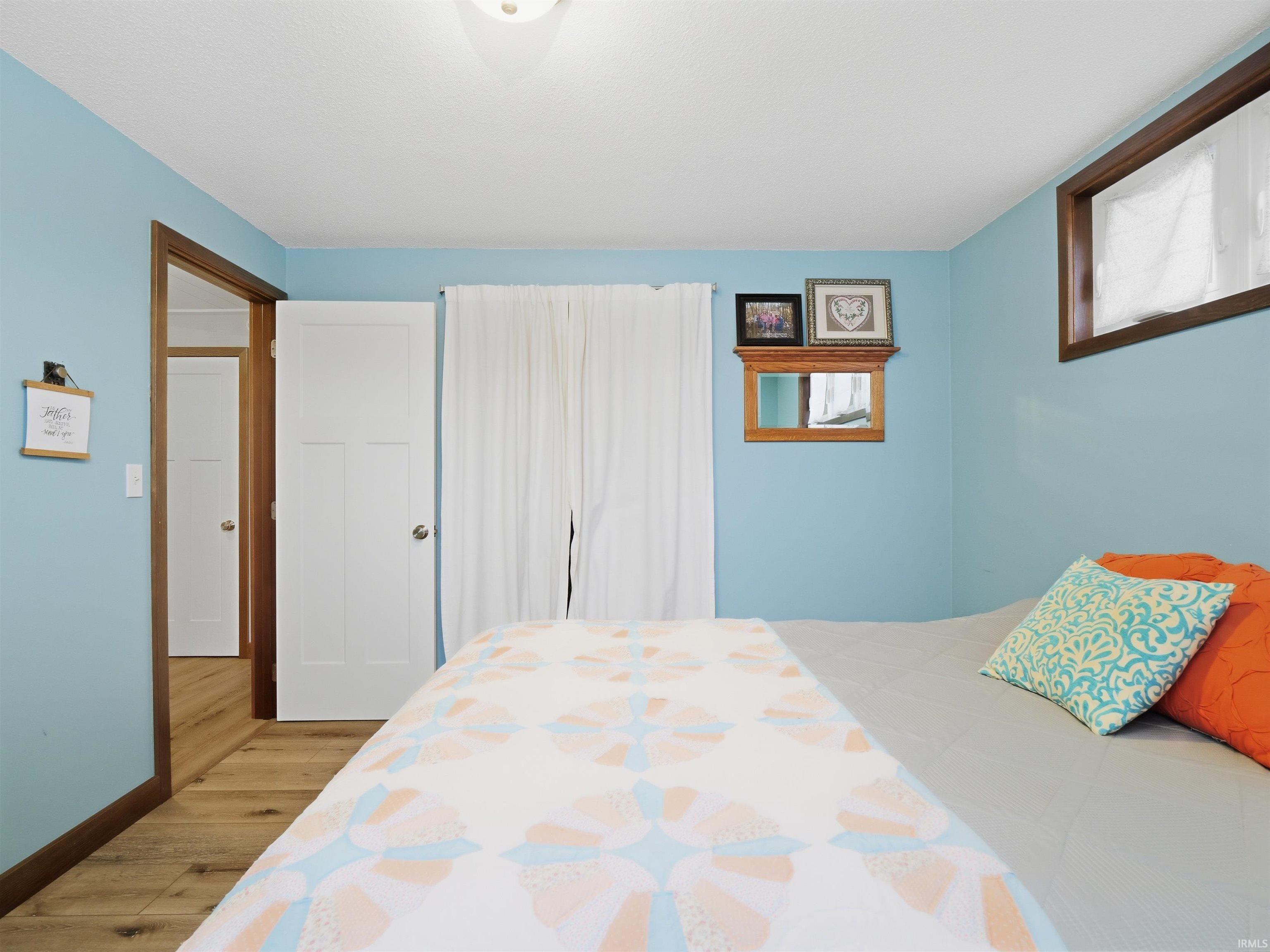 Bedroom featuring LVP floors and baseboards