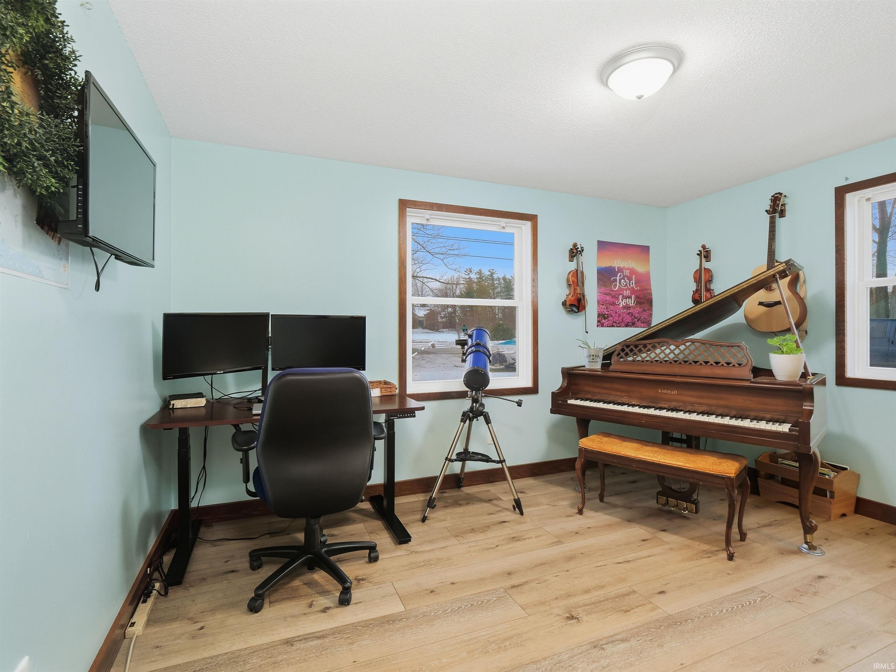 Office area featuring light wood-style flooring and baseboards