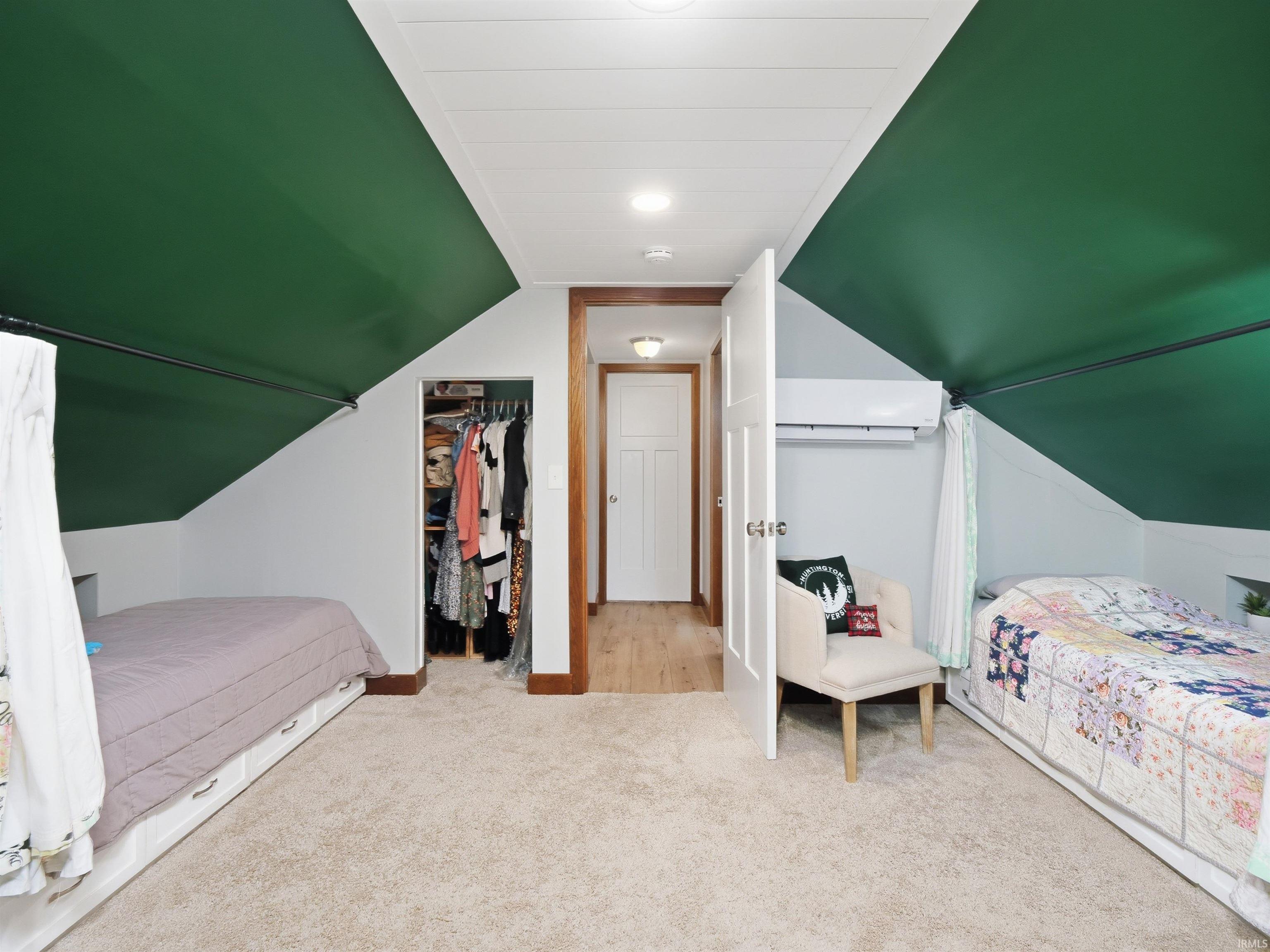 Carpeted bedroom with built-in beds.
