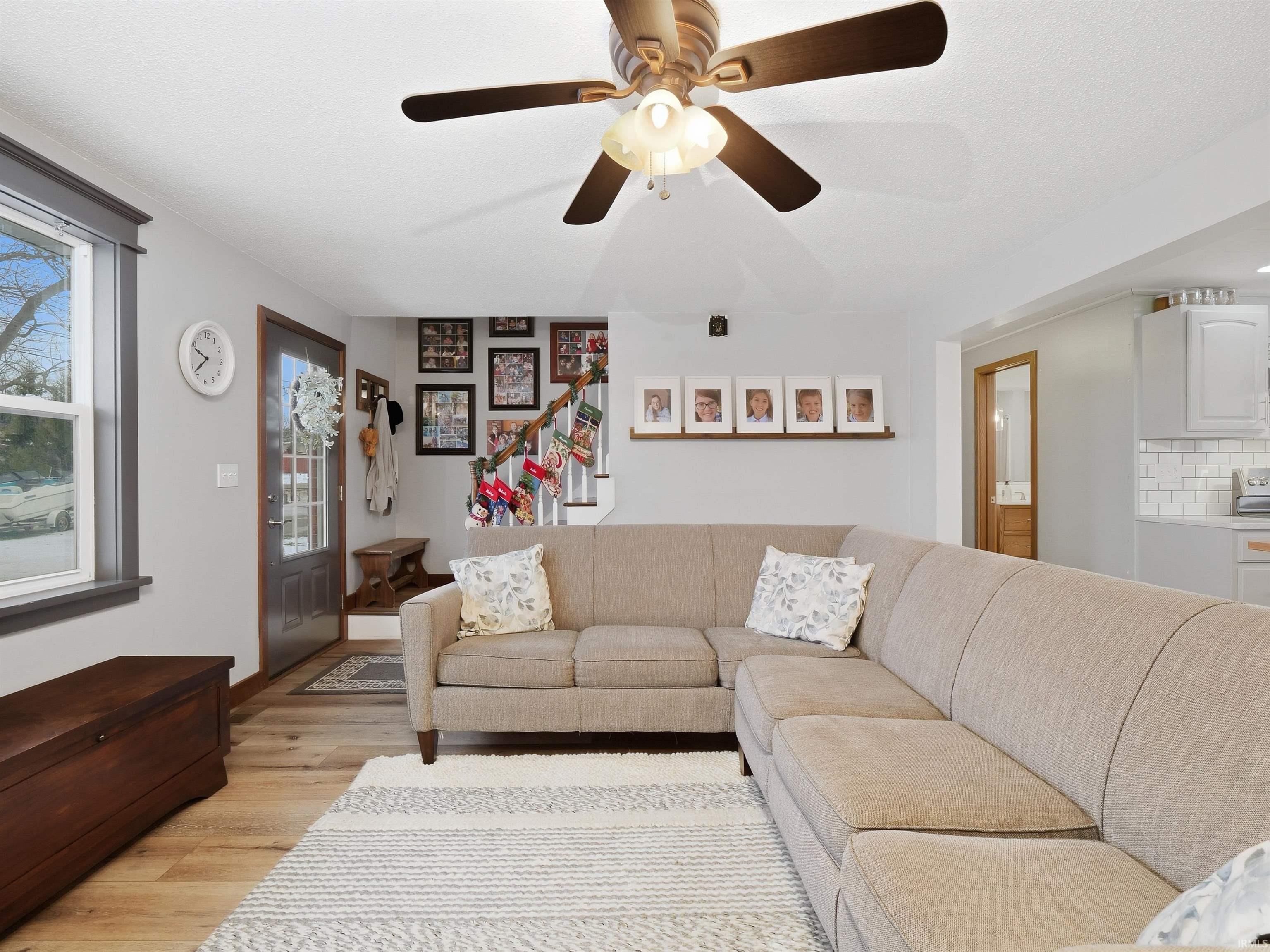 Living area with wood finished floors and a ceiling fan