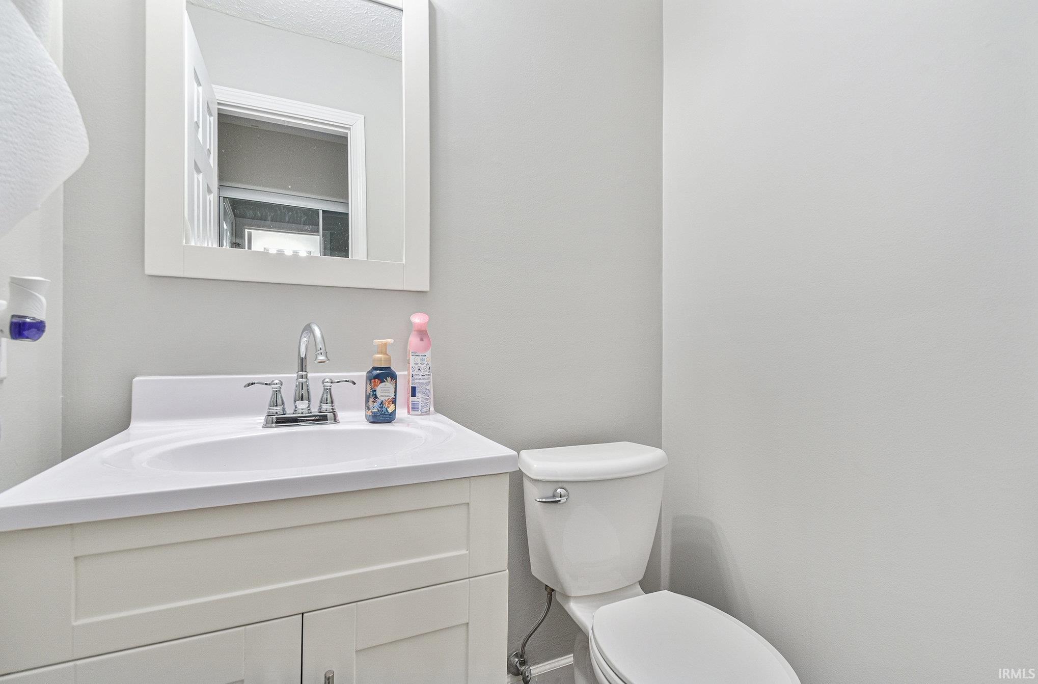 Main level powder room off the garage/ foyer area